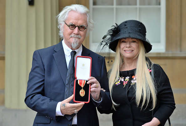 Sir Billy Connolly poses with his wife Pamela Stephenson, after being knighted by the Duke of Cambridge. (Getty Images)