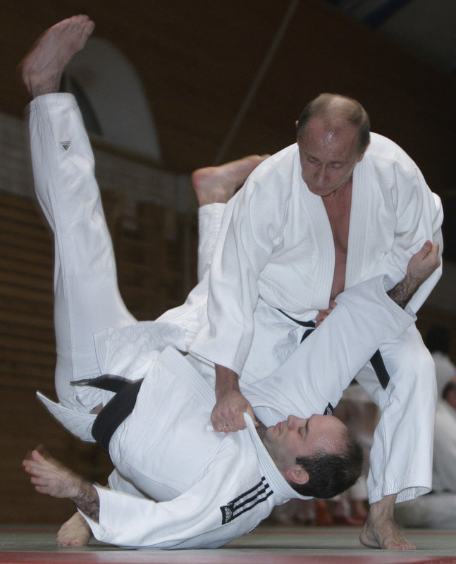 Russian Prime Minister Vladimir Putin, top, is seen during judo training at a sports school in St. Petersburg, Russia. (Getty)