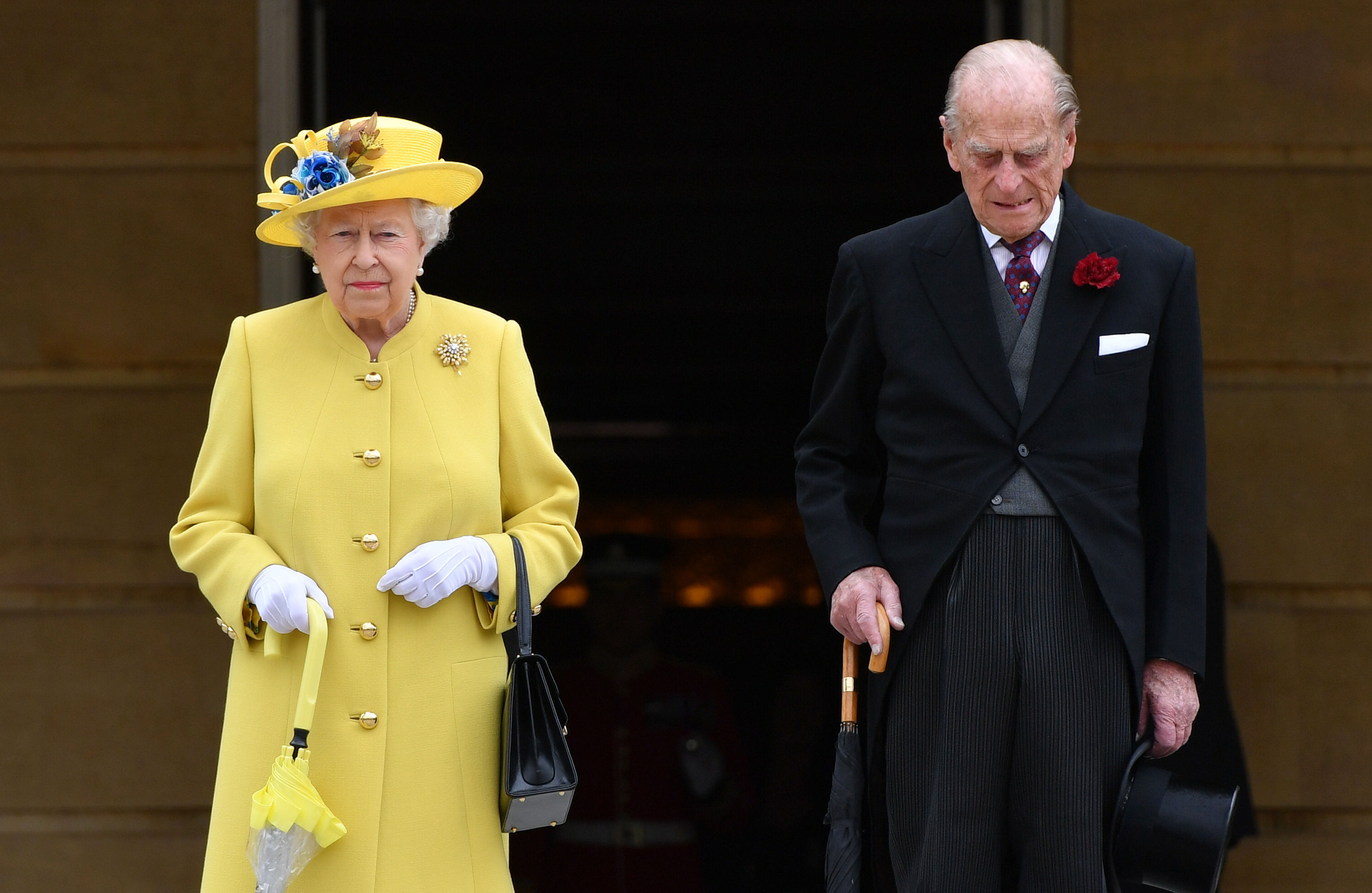 Queen Elizabeth II and Prince Philip, Duke of Edinburgh observe a minute's silence in honour of the victims of the attack at Manchester Arena at the start of a garden party at Buckingham Palace on May 23, 2017 in London, England.