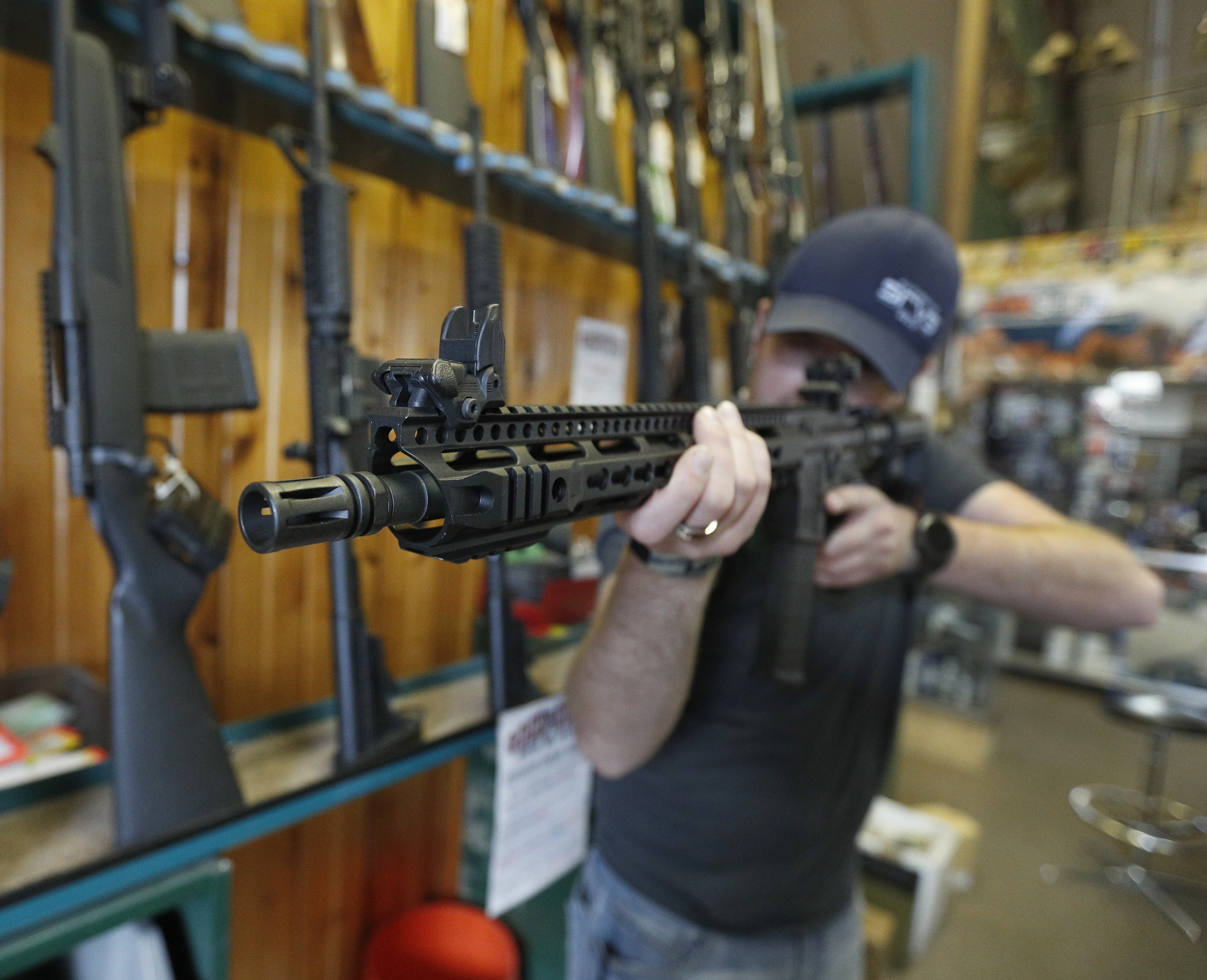 Dordon Brack aims a semi-automatic AR-15 that is for sale at Good Guys Guns & Range on February 15, 2018, in Orem, Utah. (Getty)