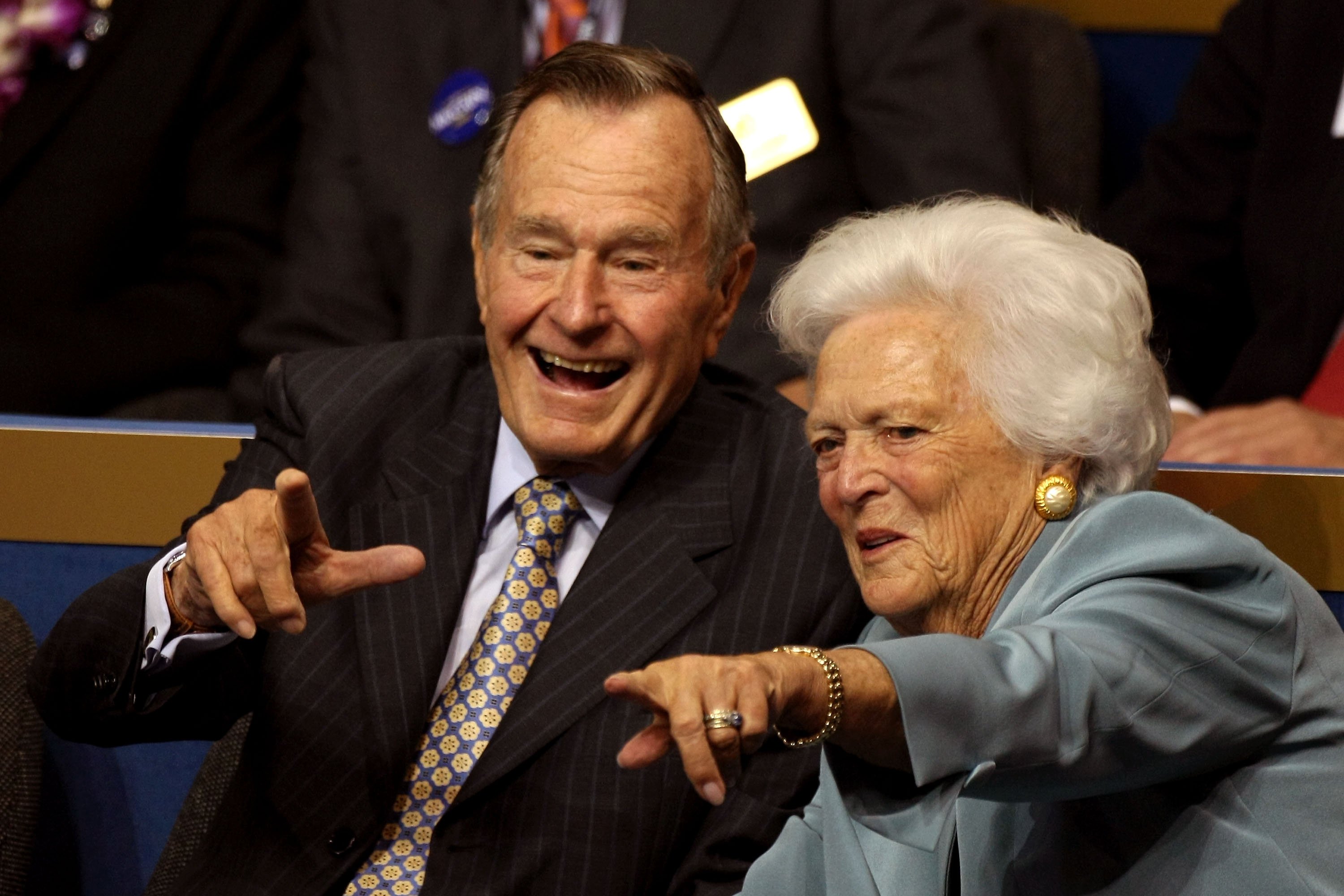 Former President George H.W. Bush (L) and former first lady Barbara Bush (C) point from their seats on day two of the Republican National Convention (RNC) at the Xcel Energy Center on September 2, 2008 in St. Paul, Minnesota.