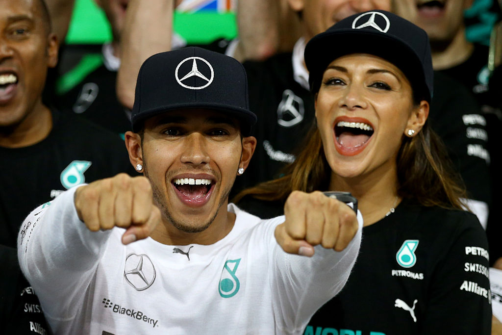 Lewis Hamilton of Great Britain and Mercedes GP celebrates with his team and Nicole Scherzinger after winning the World Championship after the Abu Dhabi Formula One Grand Prix at Yas Marina Circuit on November 23, 2014 in Abu Dhabi, United Arab Emirates. (Photo by Clive Rose/Getty Images)