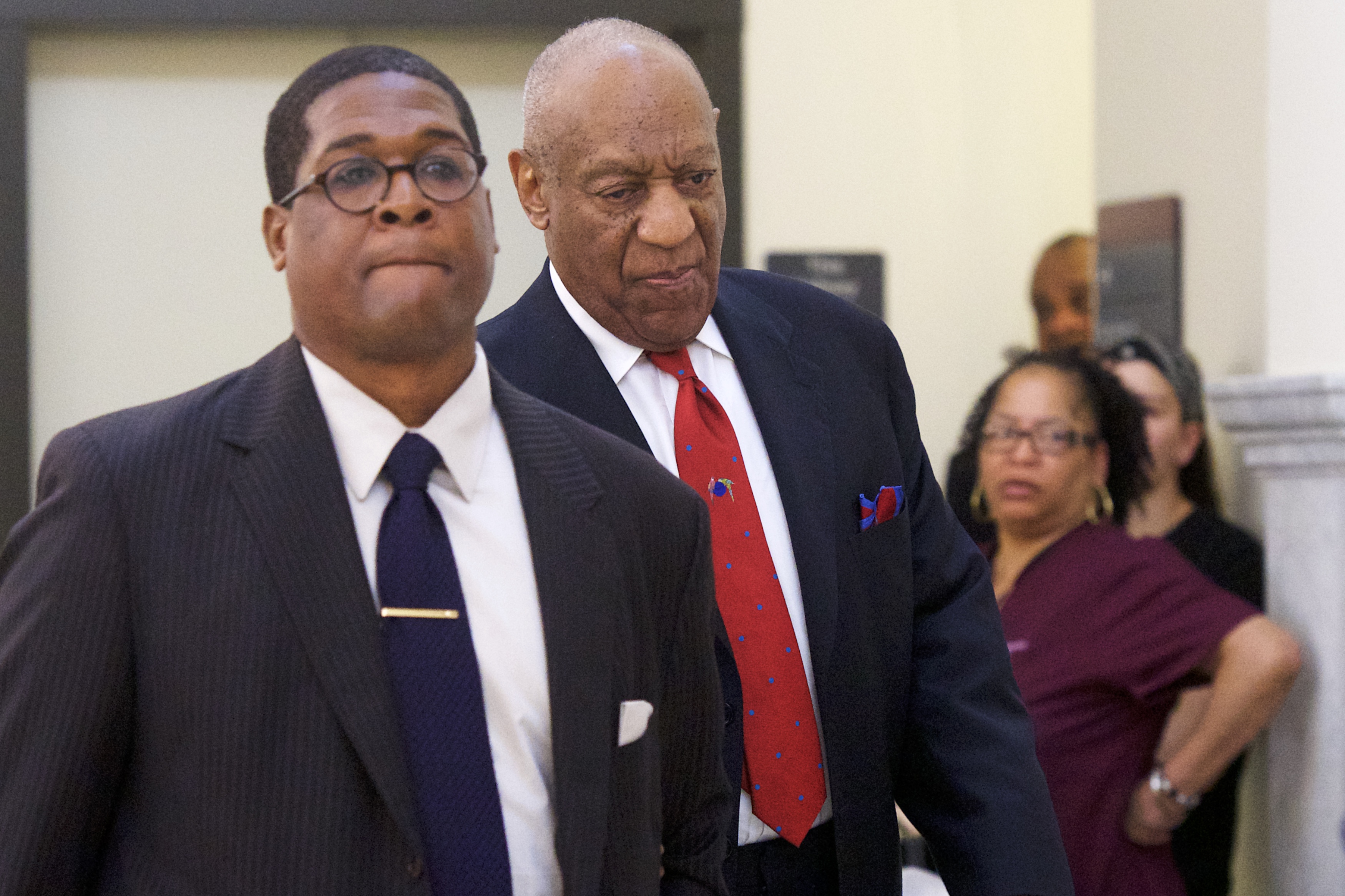 Bill Cosby (C) walks through the Montgomery County Courthouse with his publicist, Andrew Wyatt, after being found guilty on all counts in his sexual assault retrial on April 26, 2018 in Norristown, Pennsylvania. Cosby was found guilty on all accounts after a former Temple University employee alleges that the entertainer drugged and molested her in 2004 at his home in suburban Philadelphia. More than 40 women have accused the 80 year old entertainer of sexual assault.