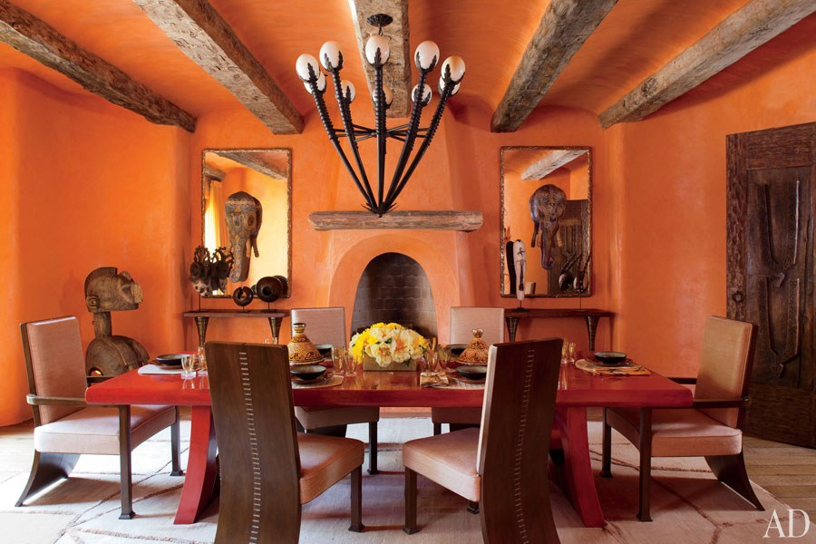 The dining room features a custom-made table sheathed in lacquered linen; the walnut dining chairs with bronze-staple detailing are upholstered in a Beacon Hill fabric, and the silk-and-wool area rug is from Woven Accents. Roger Davies 2011