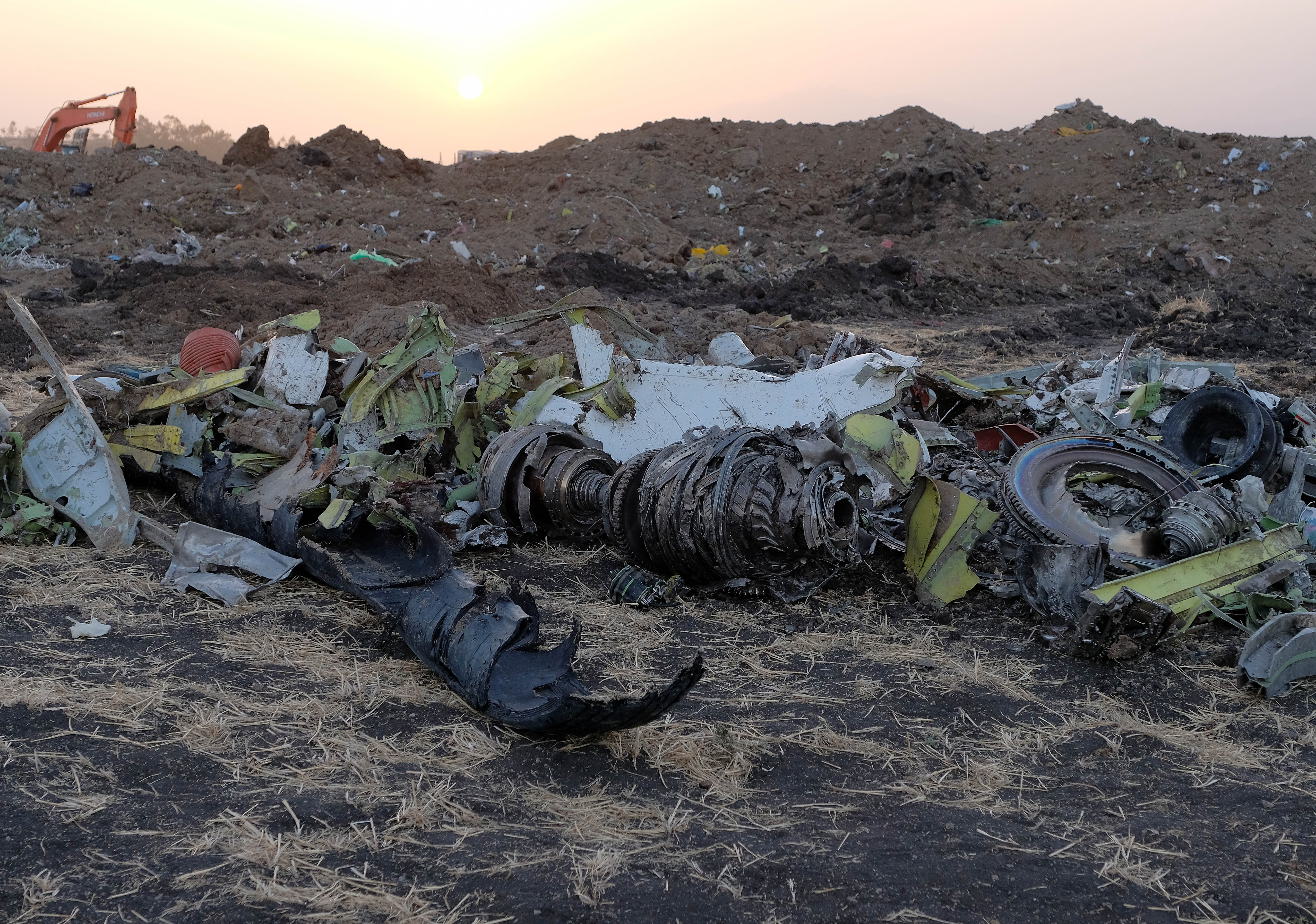 Parts of an engine and the landing gear lie in a pile after being gathered by workers during the continuing recovery efforts at the crash site of Ethiopian Airlines flight ET302 on March 11, 2019, in Bishoftu, Ethiopia. (Getty)