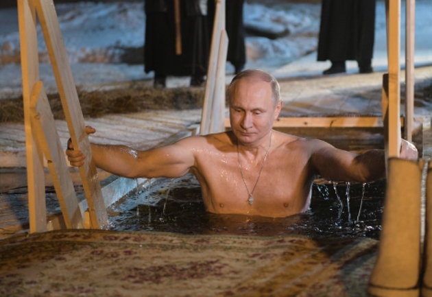 Russian President Vladimir Putin climbing out of icy waters. (Getty)