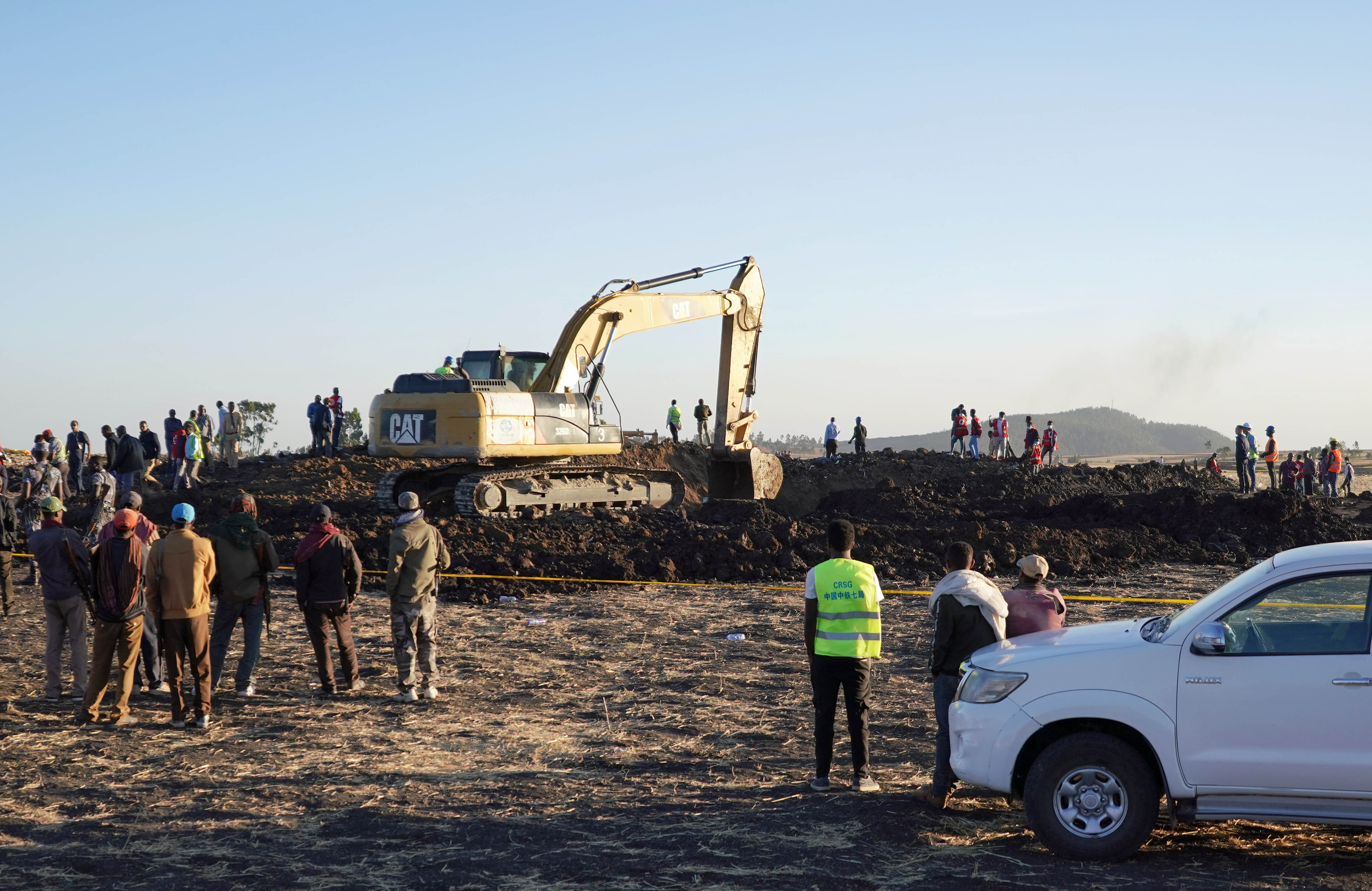 Rescue and recovery personnel use an earth mover to recover debris from a crater where Ethiopian Airlines Flight 302 crashed in a wheat field just outside the town of Bishoftu, 62 kilometers southeast of Addis Ababa on March 10, 2019, in Addis Ababa, Ethiopia. (Getty Images)