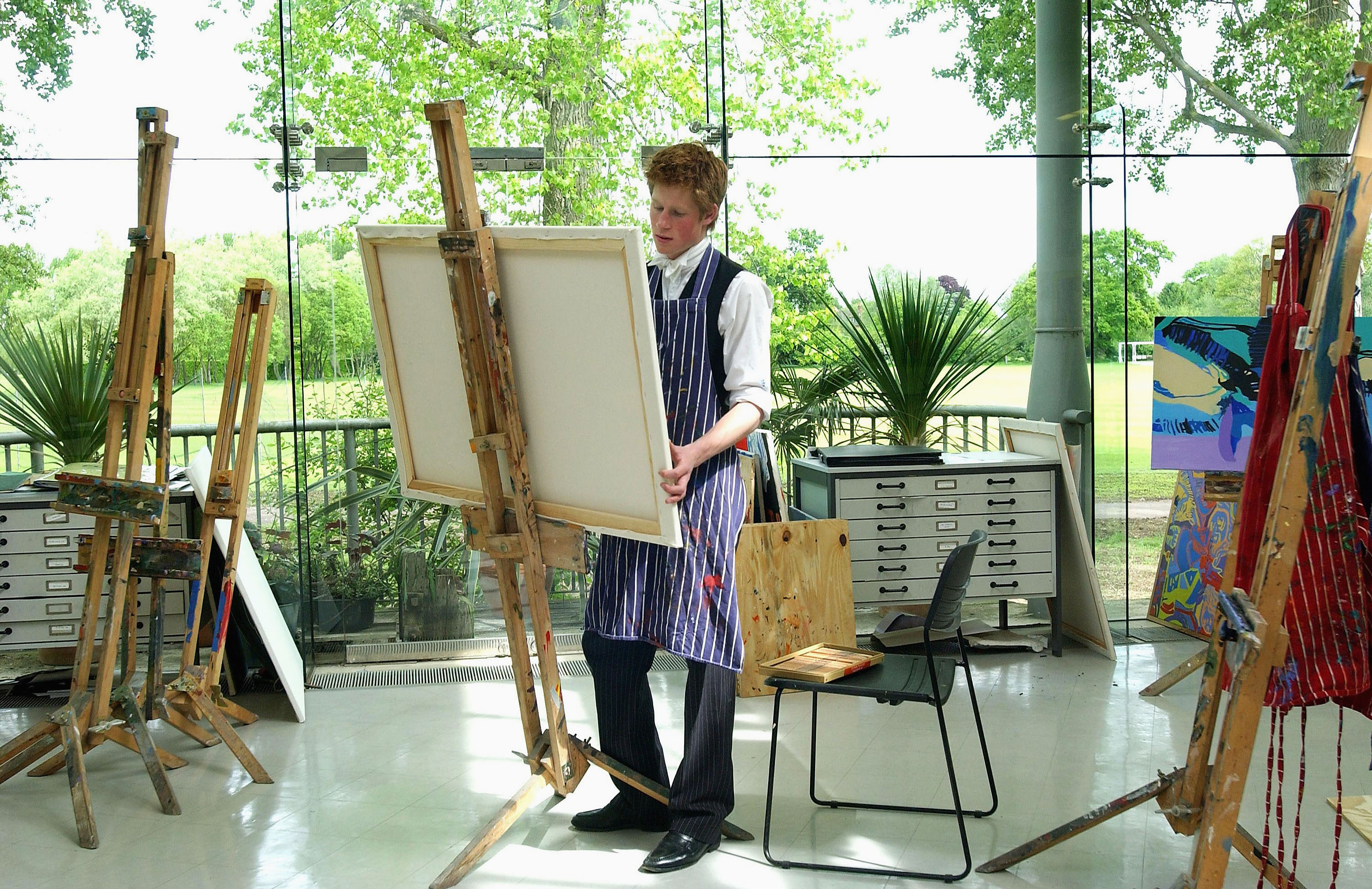 (FILE PHOTO) The youngest son of the Prince of Wales, Prince Harry at work on May 12, 2003 in the Drawing School at Eton College, Eton in England. The Royal Family on October 9, 2004 denied allegations that the Prince had cheated in his art A-level