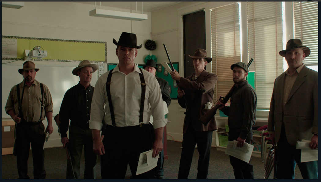The townspeople can be seen playing the characters of the deputies in a still from Bisbee'17.