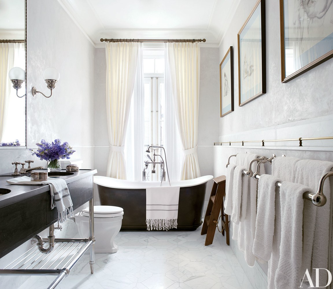 The master bath includes a freestanding tub at the window, a custom-designed vanity by MADE, and a Walker Zanger tile floor.