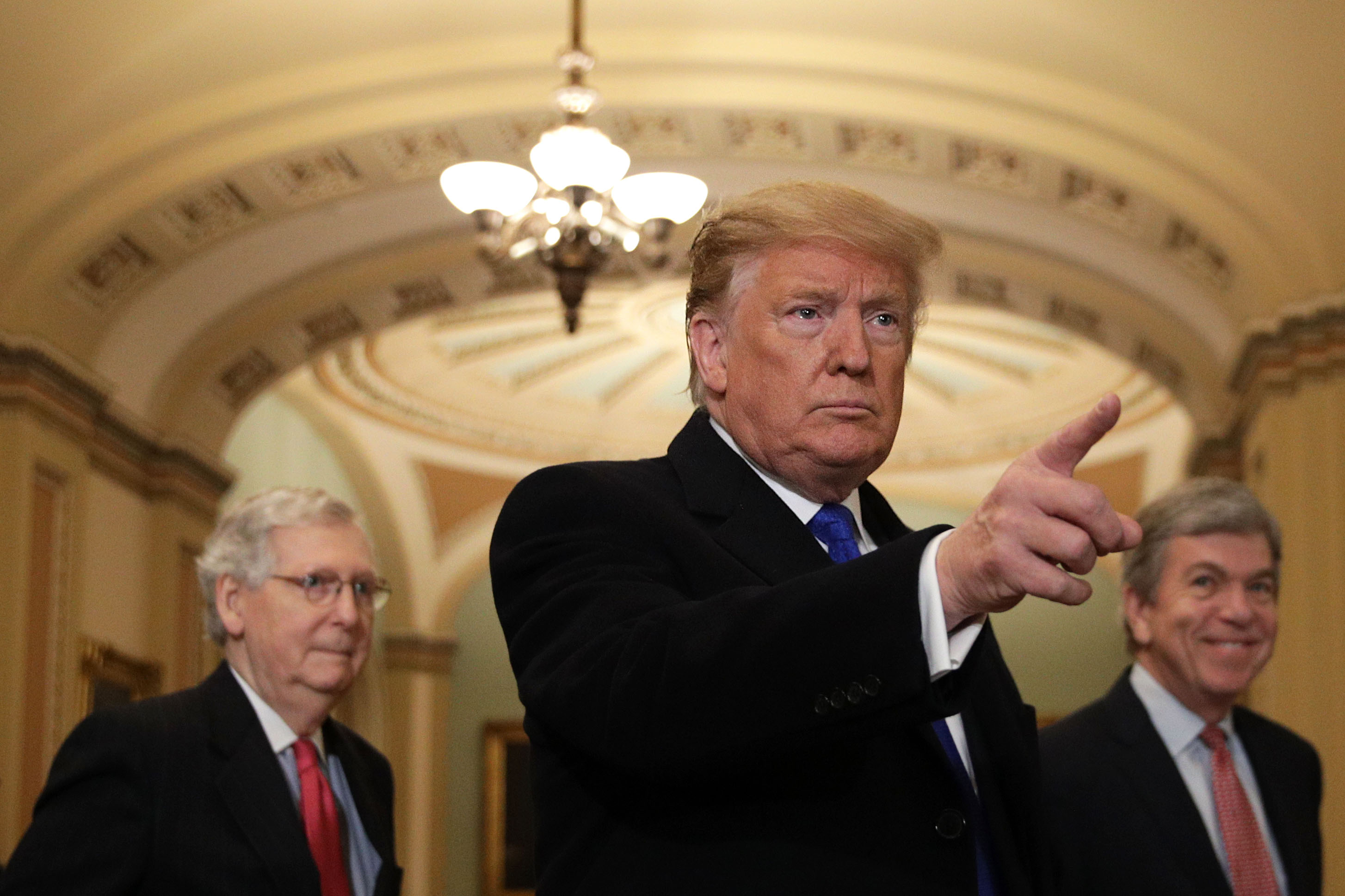 U.S. President Donald Trump (C) speaks to members of the media as Senate Majority Leader Sen. Mitch McConnell (R-KY) (L), and Sen. Roy Blunt (R-MO) (R) look on after he arrived at a Senate Republican weekly policy luncheon at the U.S. Capitol March 26, 2019 in Washington, DC. Congressional top Democrats have demanded Attorney General William Barr to release special counsel Robert Mueller’s investigation report for the alleged Russian interference in the 2016 presidential election.