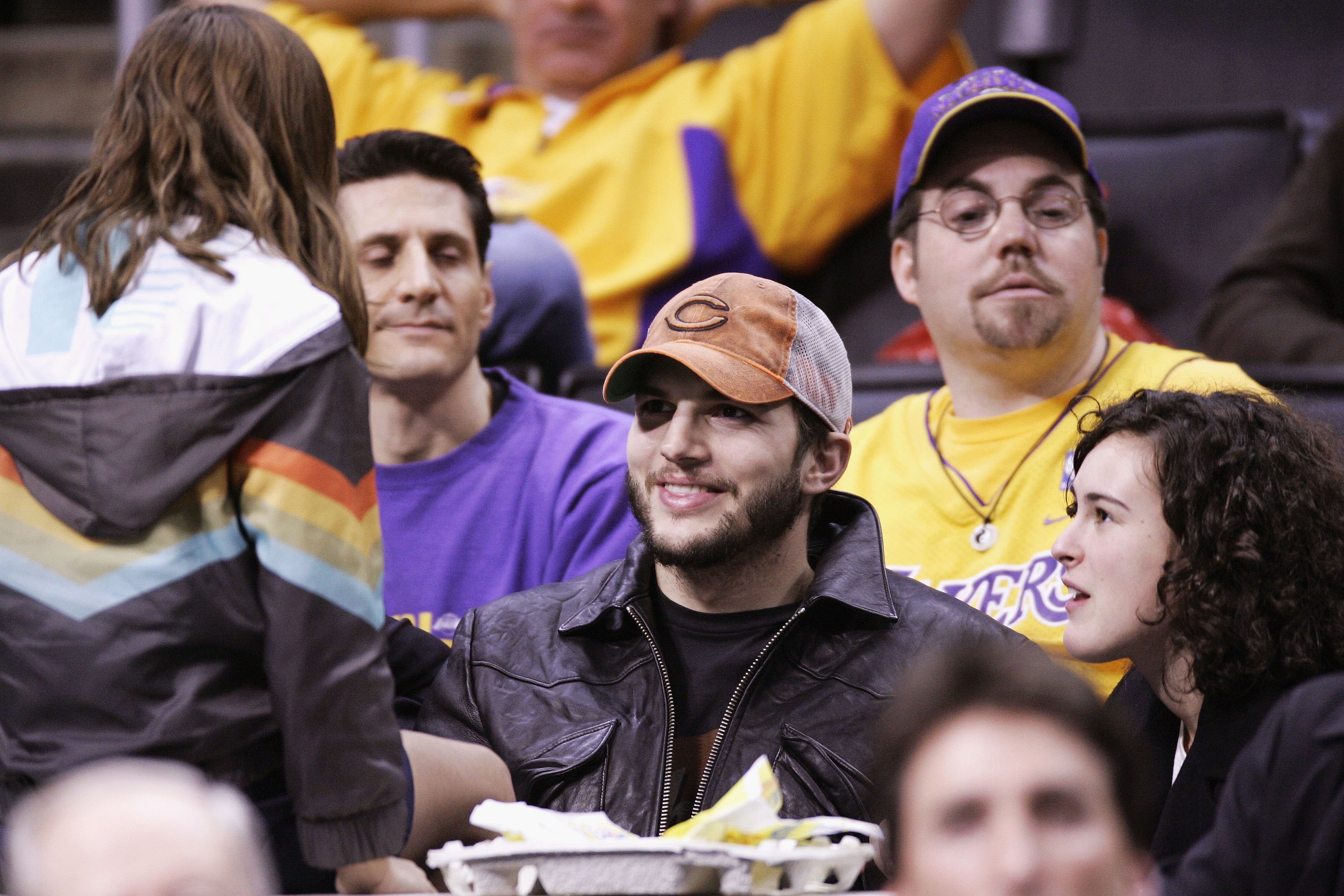 Actor Ashton Kutcher and step daughter Rumer Willis (R) attend the Los Angeles Lakers-Phoenix Suns playoff game on April 28, 2006 at Staples Center in Los Angeles, California.