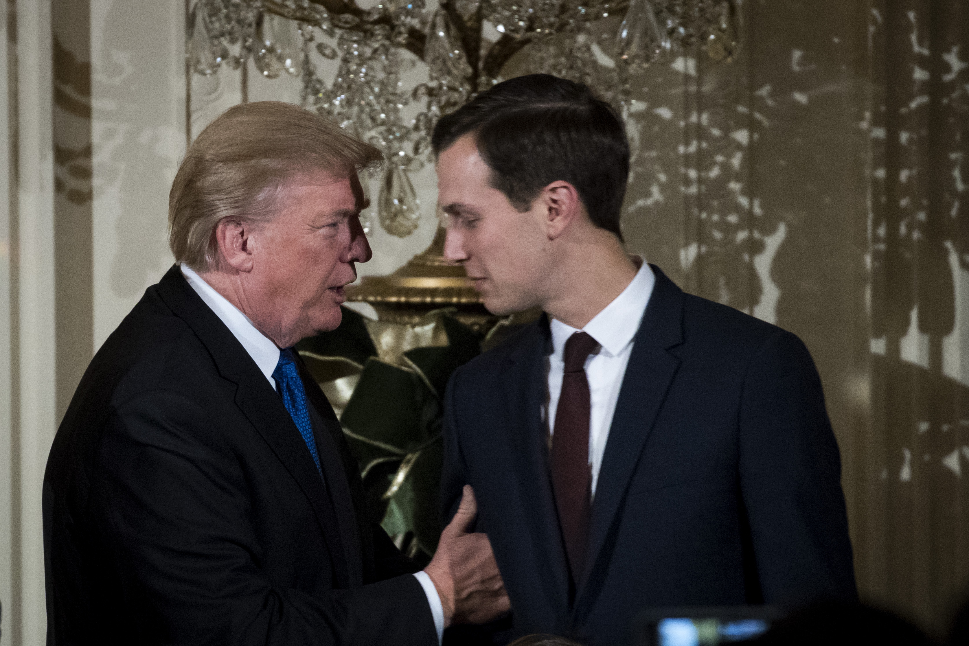 U.S. President Donald Trump talks with White House Senior Advisor to the President Jared Kushner as they attend a Hanukkah Reception in the East Room of the White House, December 7, 2017, in Washington, DC. (Getty Images)