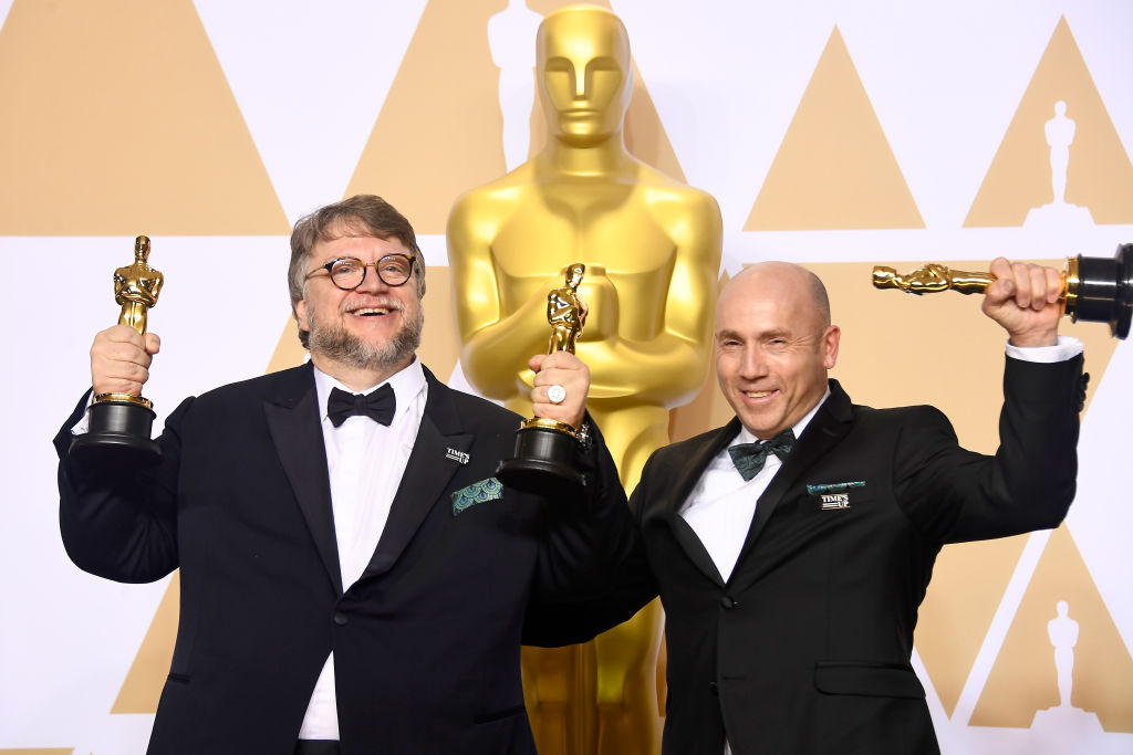 Filmmaker Guillermo del Toro (L), winner of the Best Director and Best Picture awards for 'The Shape of Water,' and producer J. Miles Dale, winner of the Best Picture award for 'The Shape of Water,' pose in the press room during the 90th Annual Academy Awards at Hollywood & Highland Center on March 4, 2018 in Hollywood, California. (Photo by Frazer Harrison/Getty Images)