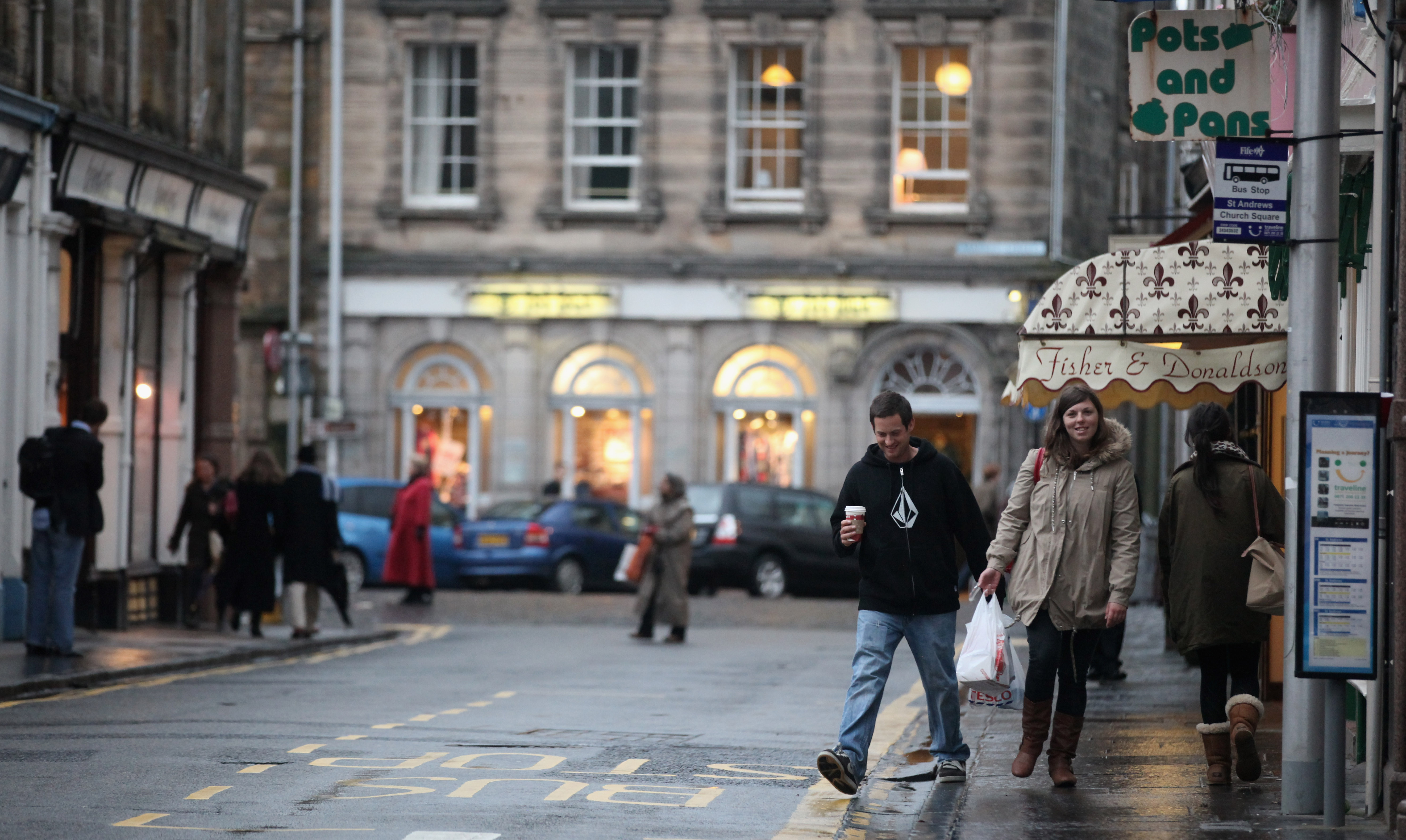 People walk past shops on November 22, 2010 in St Andrews, Scotland. The newly engaged Prince William and Kate Middleton studied at the University of St Andrews and will marry in the spring or summer of 2011.