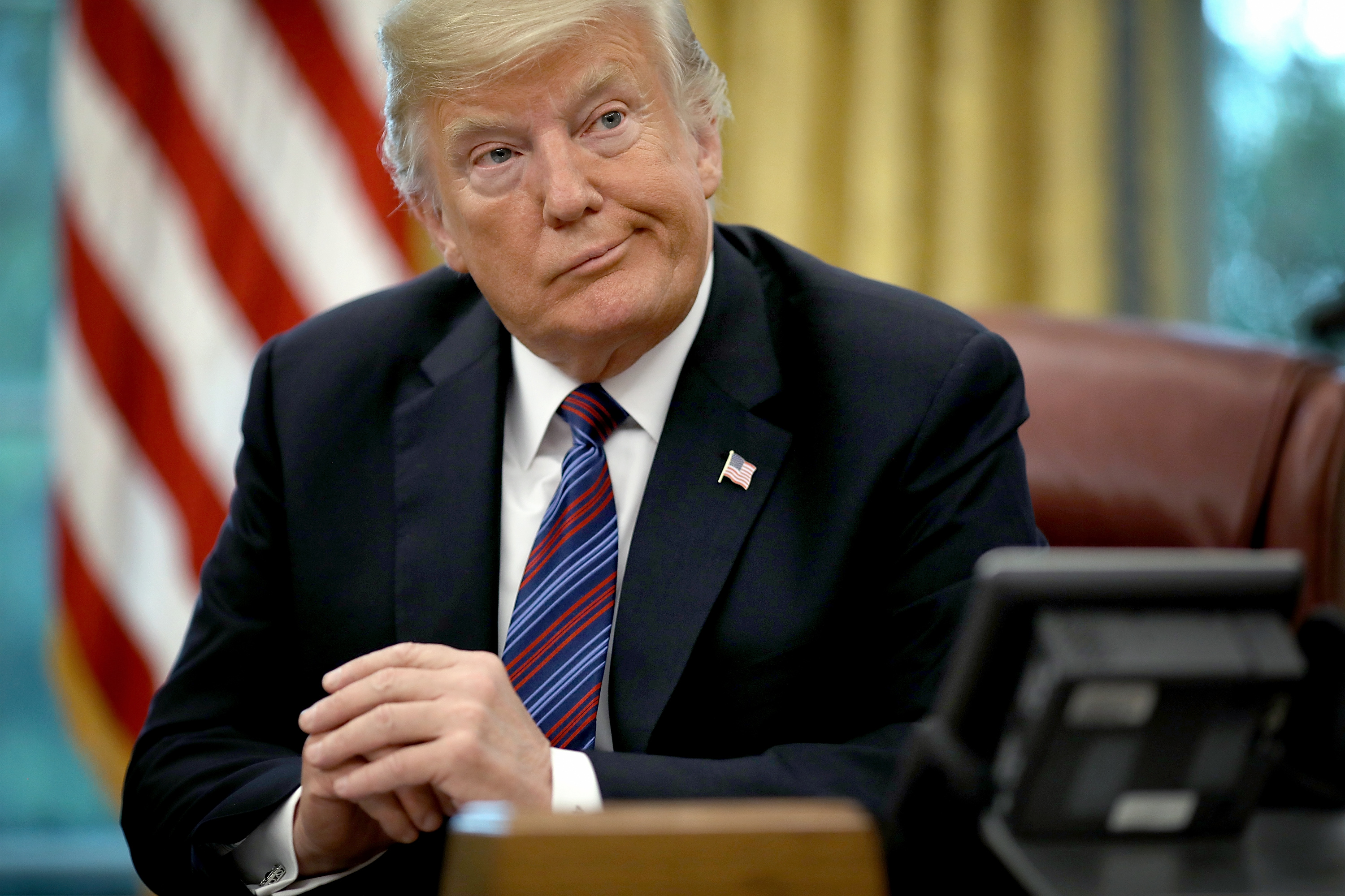 U.S. President Donald Trump photographed while on the telephone via speakerphone with Mexican President Enrique Pena Nieto in the Oval Office of the White House on August 27, 2018 in Washington, DC. Trump announced that the United States and Mexico have reached a preliminary agreement on trade.
