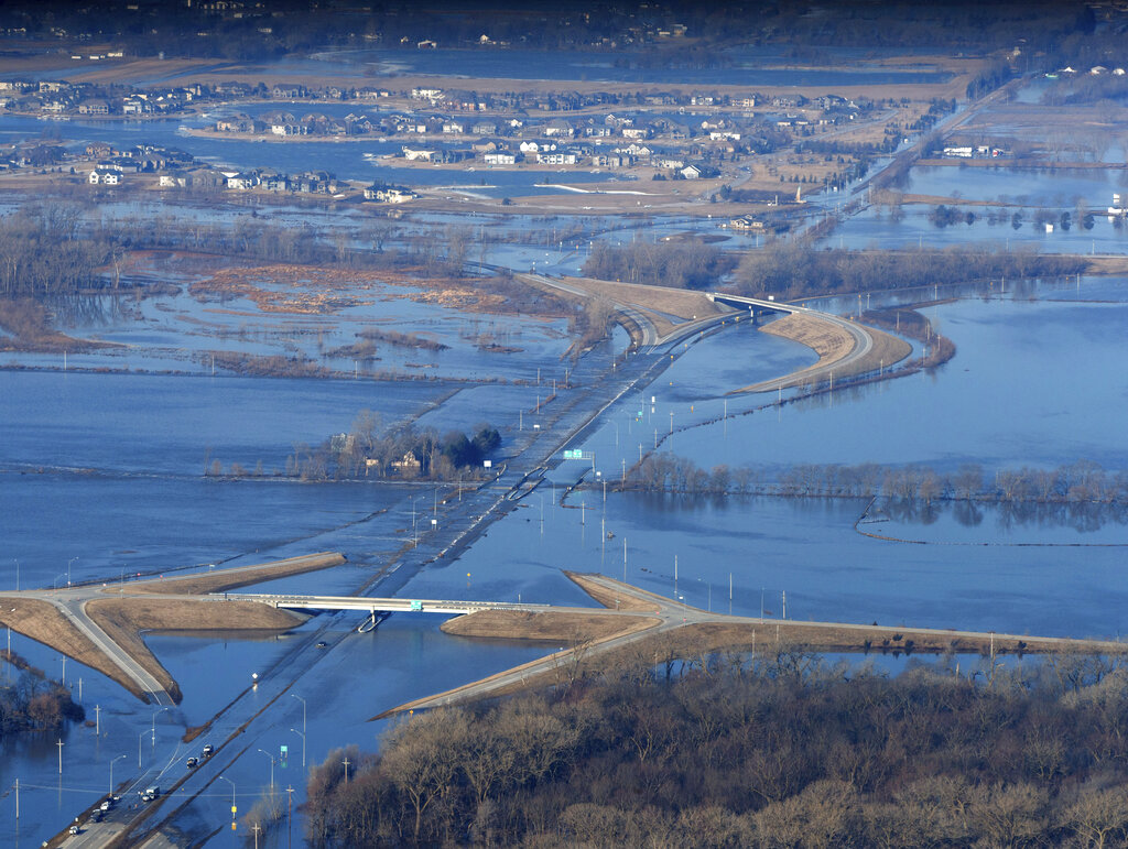 The Elkhorn River consumes a section of western Douglas County Sunday, March 17, 2019, in Omaha, Neb (Jeff Bundy/Omaha World-Herald via AP)