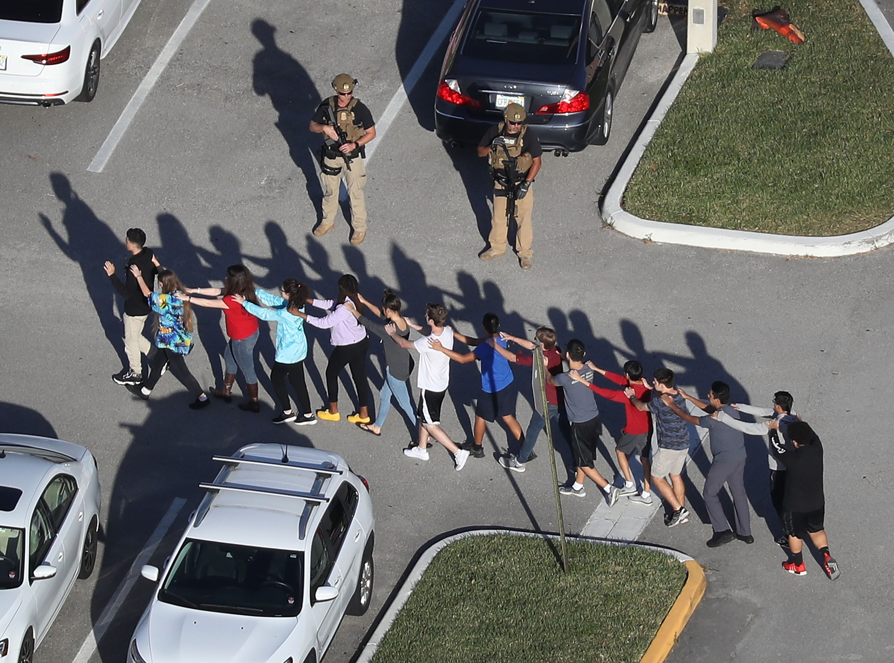 People are brought out of the Marjory Stoneman Douglas High School after a shooting at the school that reportedly killed and injured multiple people on February 14, 2018, in Parkland, Florida. (Getty Images)