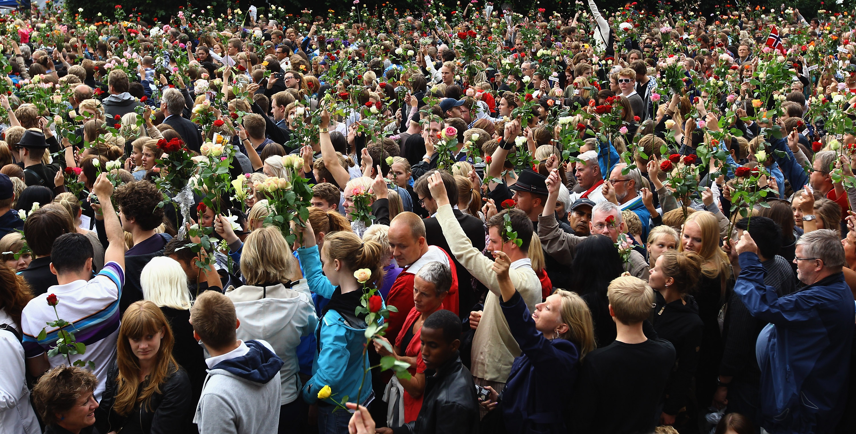 An estimated 100,000 people gather in Oslo town center for a vigil following Friday's twin extremist attacks on July 25, 2011, in Oslo, Norway. Anders Behring Breivik, 32, claimed that he has 'two more cells' working with him as he appeared in court today following a bomb blast at a government building in Oslo and a shooting massacre on nearby Utoya Island that killed at least 76 people in all. The death toll was originally reported as 93. Breivik has been detained for eight weeks, four of which in full isolation. (Source: Jeff J Mitchell/Getty Images)