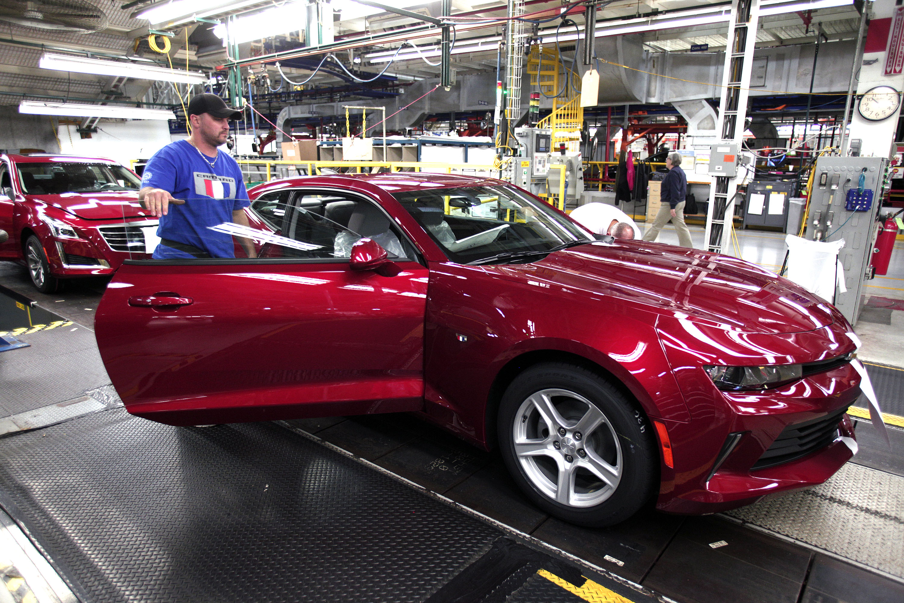 A GM worker puts the finishing touches on a new General Motors 2016 Chevrolet Camaro as it rolls off the production line at GM's Lansing Grand River Assembly Plant October 26, 2015 in Lansing, Michigan.