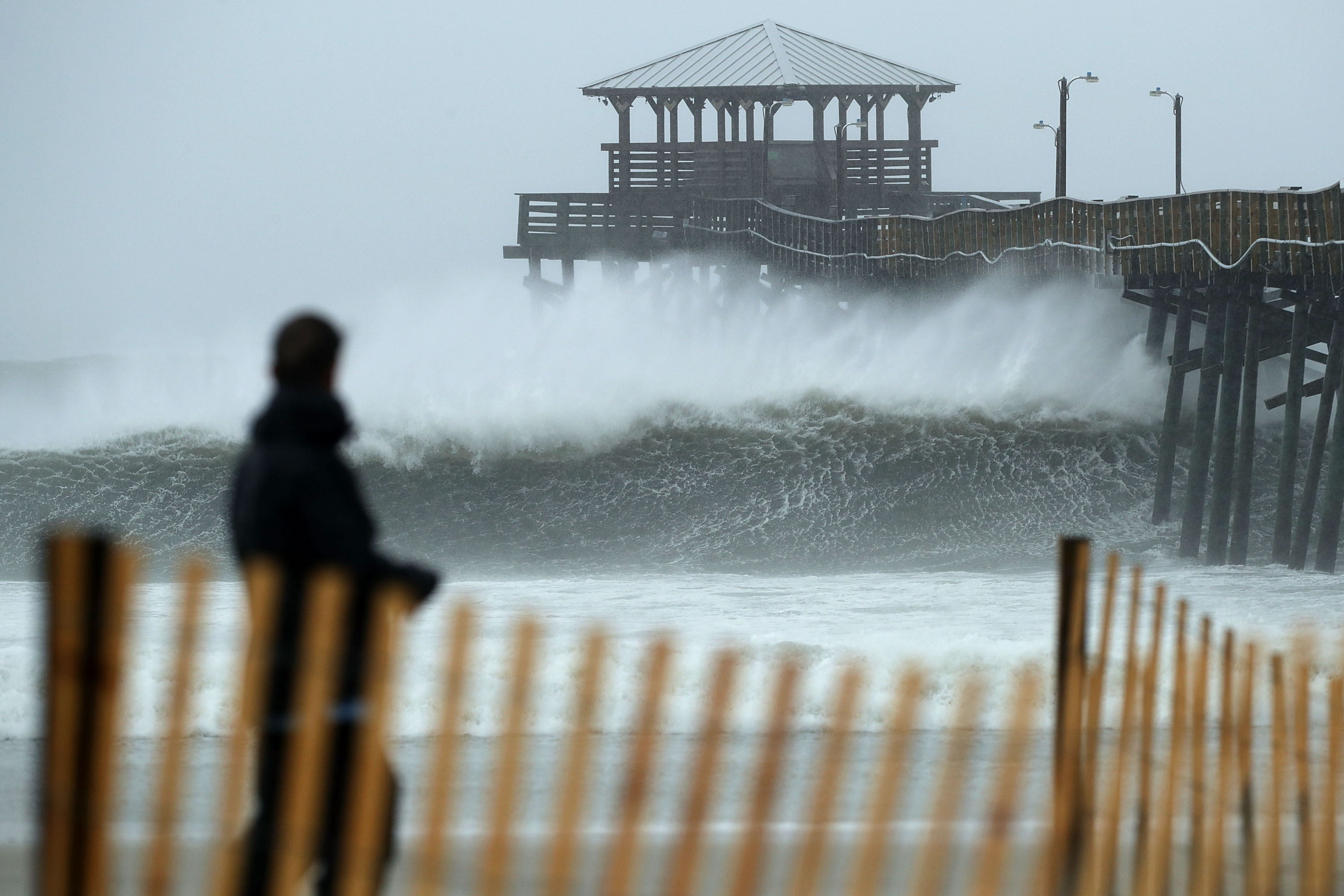 Waves crash underneath the Oceanana Pier as the outer bands of Hurricane Florence being to affect the coast September 13, 2018 in Atlantic Beach, United States. Coastal cities in North Carolina, South Carolina and Virginia are under evacuation orders as the Category 2 hurricane approaches the United States.