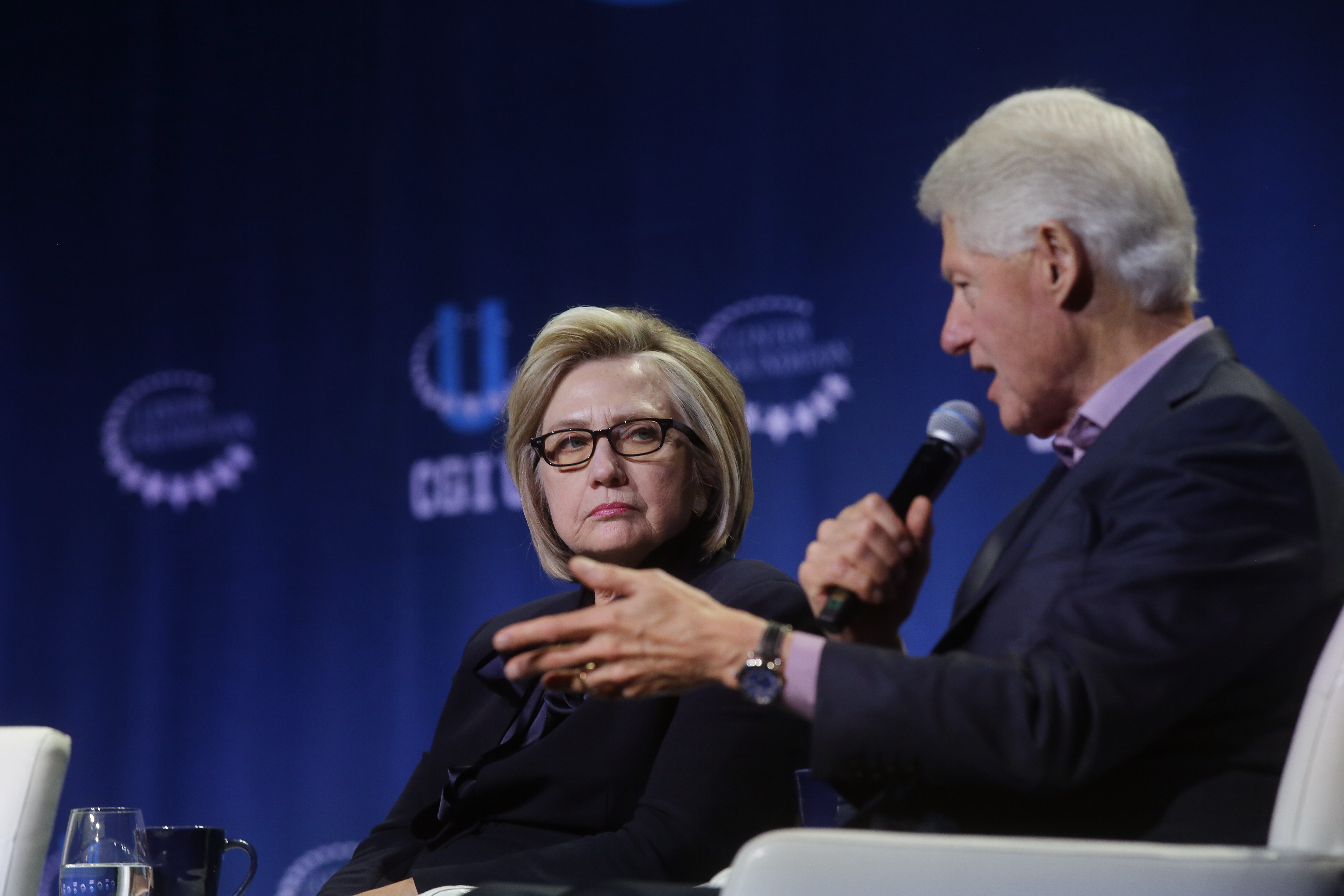 Former Secretary of State Hillary Clinton listens as former President Bill Clinton speaks during the annual Clinton Global Initiative conference at the University of Chicago on October 16, 2018 in Chicago, Illinois.