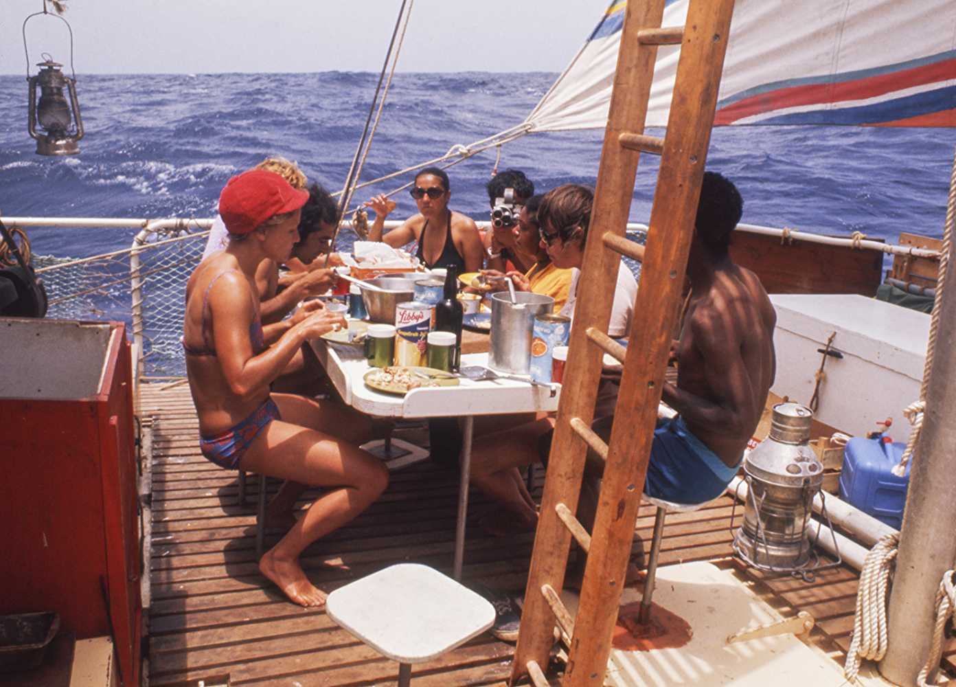 The crew sitting down for a meal (Source: IMDb)