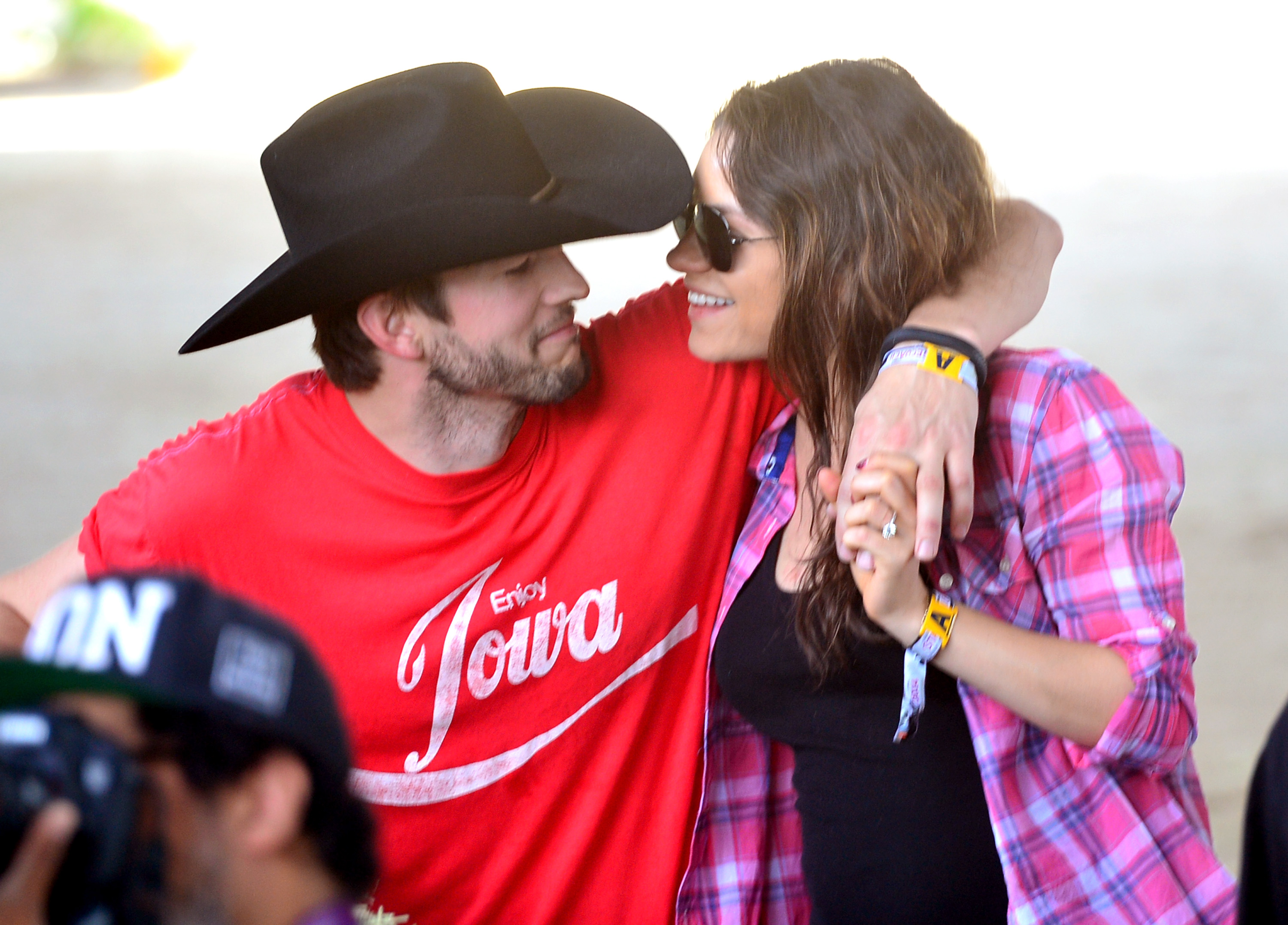 Actors Ashton Kutcher (L) and Mila Kunis attend day 1 of 2014 Stagecoach: California's Country Music Festival at the Empire Polo Club on April 25, 2014 in Indio, California.