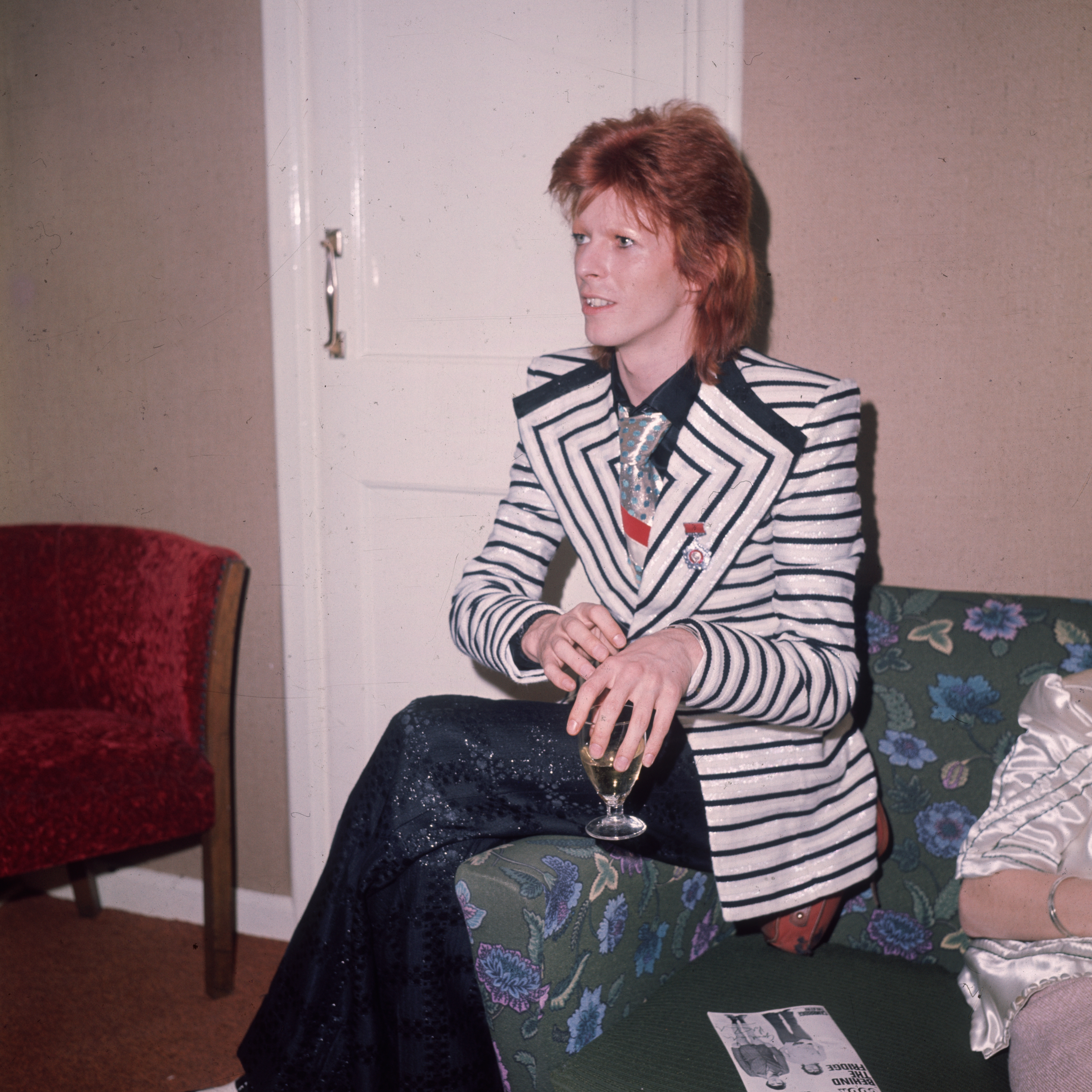 In a black and white horizontally striped jacket with wide lapels glam rock star David Bowie. Source: Getty