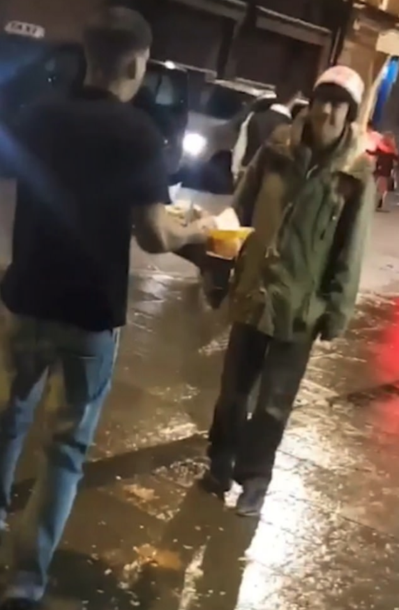 Adam Thorpe seen offering the homeless man his kebabs and fried (Source: Facebook)