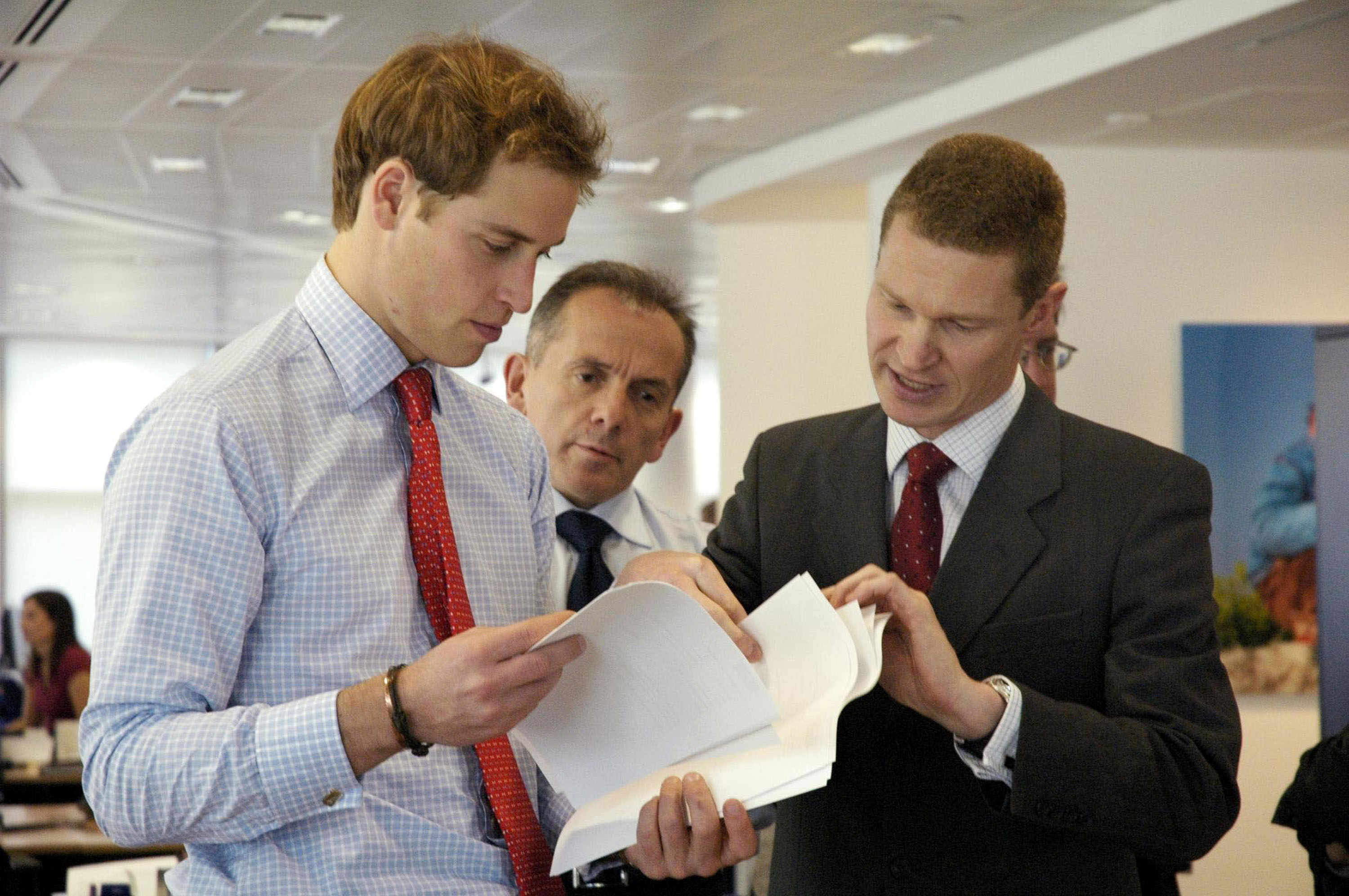 Prince William with Hiscox Plc MD, Steve Langan and James Standen of Aon look at fine art risks at the specialist insurance company's office in London Wednesday November 16 2005. (Photo by Anwar Hussein Collection/ROTA/WireImage)