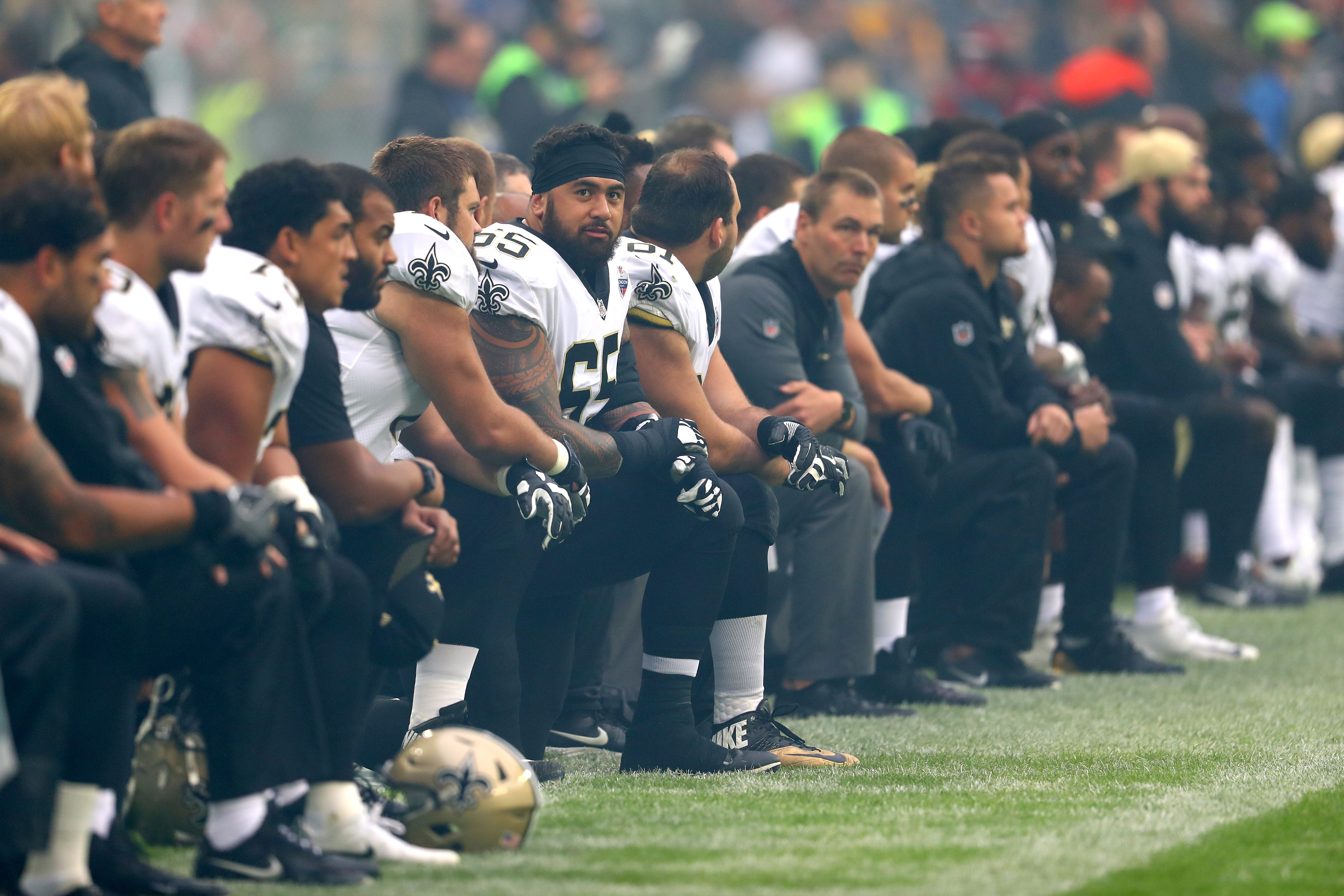 New Orleans Saints players and team kneel prior to the NFL match between New Orleans Saints and Miami Dolphins at Wembley Stadium on October 1, 2017 in London, England.