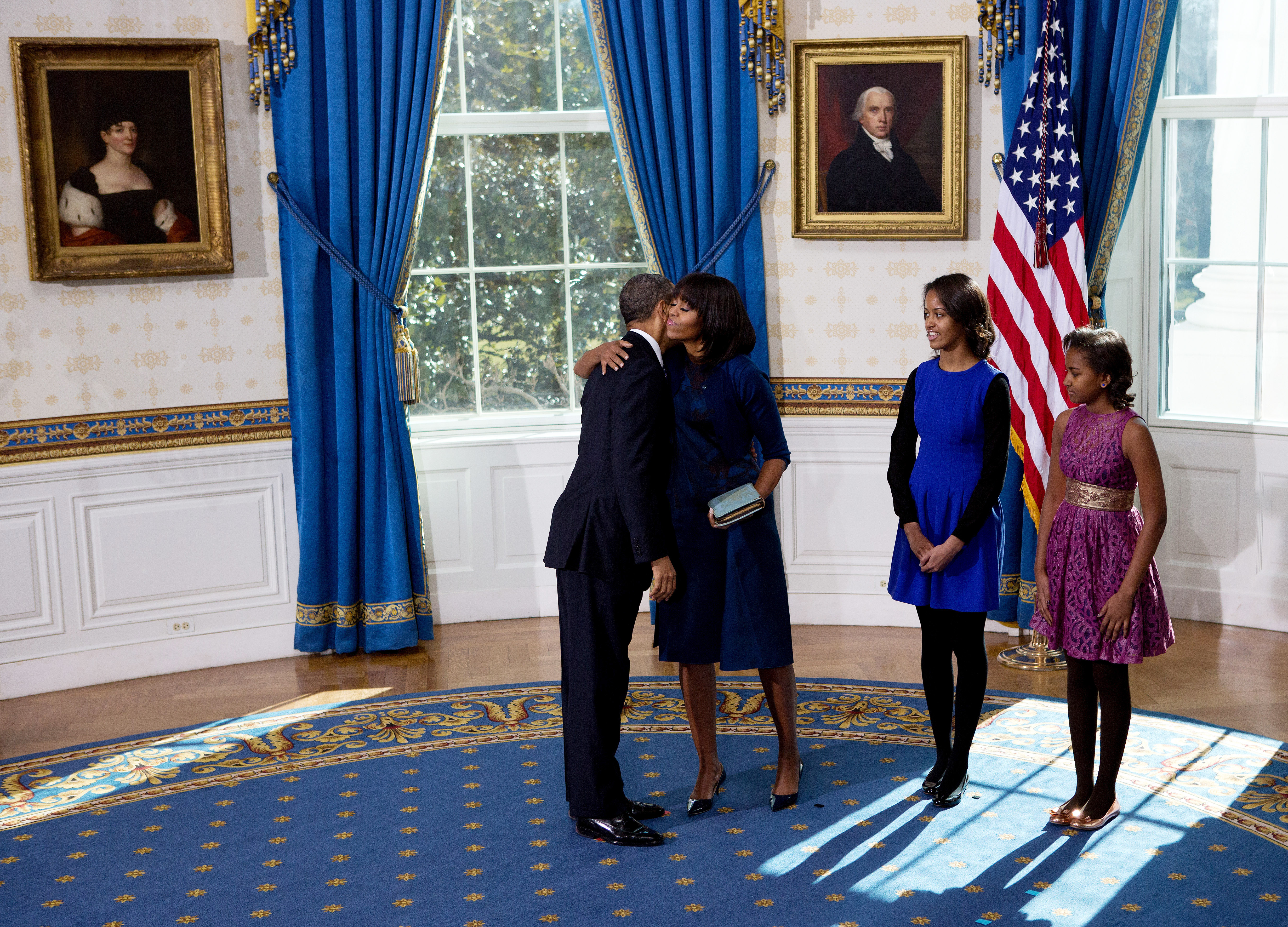 U.S President Barack Obama (L) hugs the first lady Michelle Obama (2nd L) as daughters Malia (C) and Sasha look on after taking the oath of office in the Blue Room of the White House January 20, 2013 in Washington, DC. (Getty Images)