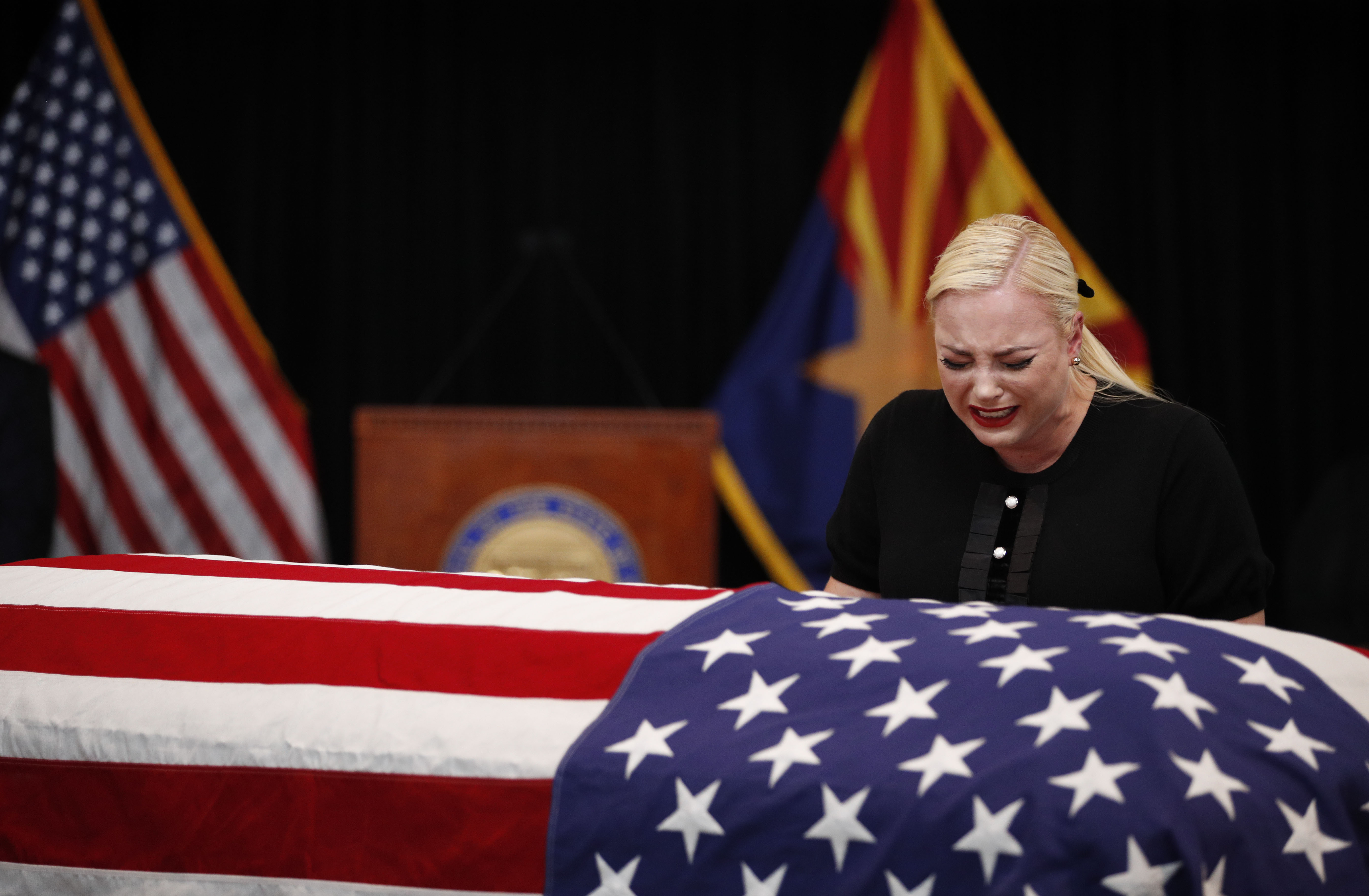 Meghan McCain, daughter of Sen. John McCain, touches the casket during a memorial service at the Arizona Capitol on August 29, 2018, in Phoenix, Arizona. John McCain will lie in state at the Arizona State Capitol before being transported to Washington D.C. where he will be buried at the U.S. Naval Academy Cemetery in Annapolis. Sen. McCain, a decorated war hero, died August 25 at the age of 81 after a long battle with Glioblastoma, a form of brain cancer. (Getty Images)