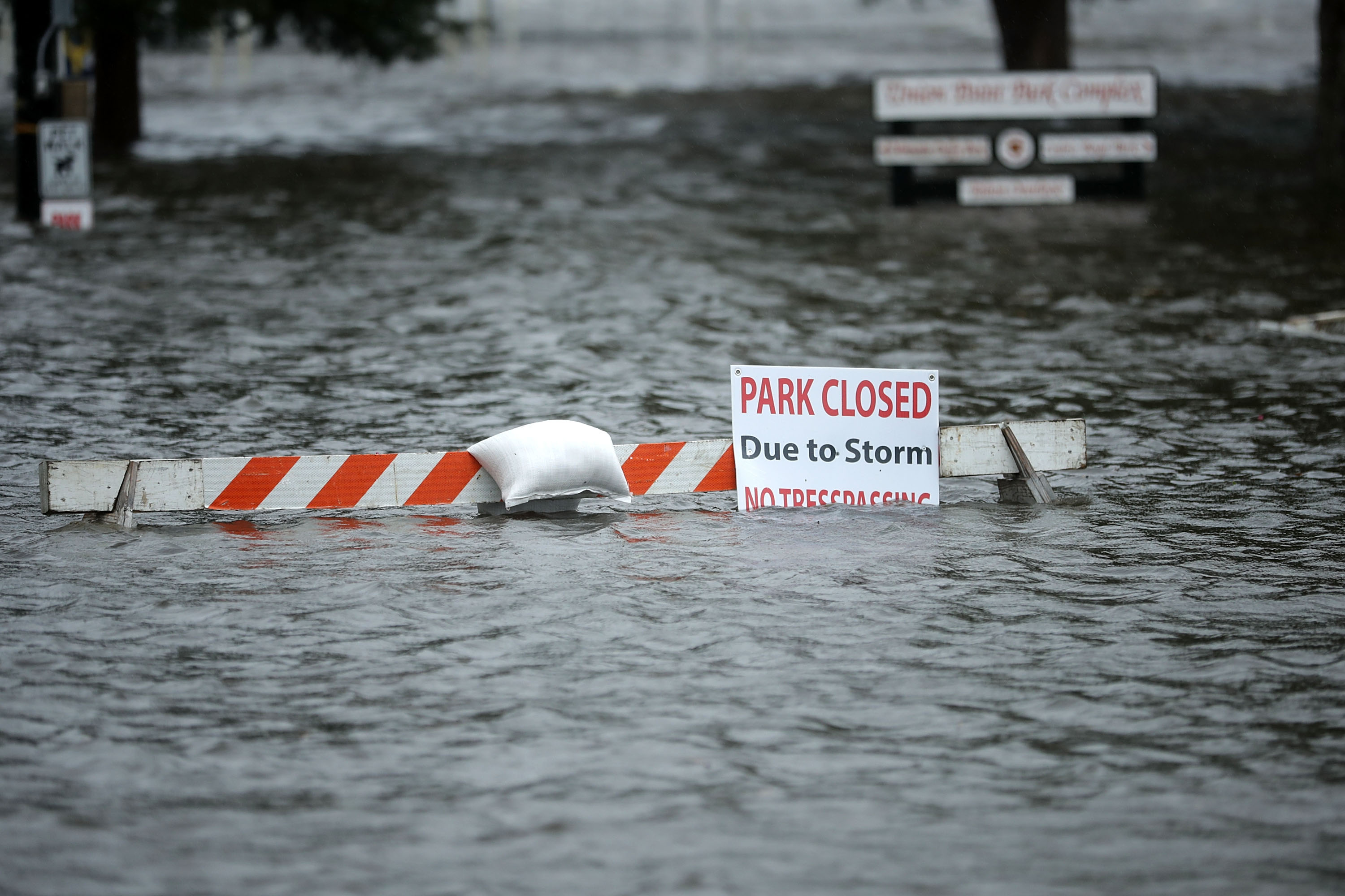A sign warns people away from Union Point Park after is was flooded by the Neuse River during Hurricane Florence September 13, 2018 in New Bern, North Carolina. Coastal cities in North Carolina, South Carolina and Virginia are under evacuation orders as the Category 2 hurricane approaches the United States.
