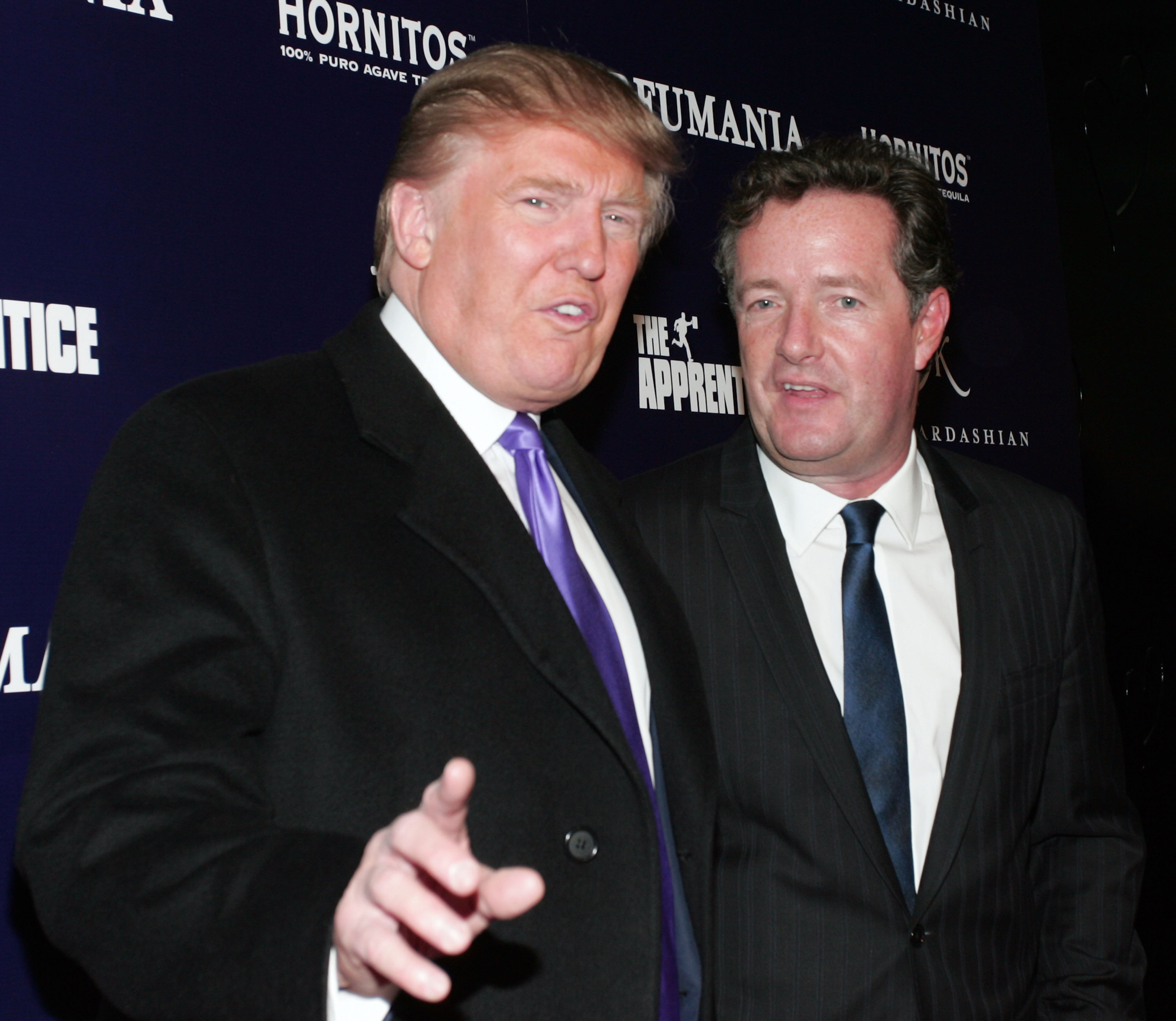 Donald Trump (L) and Piers Morgan celebrate Kim Kardashian's appearance on 'The Apprentice' at Provacateur on November 10, 2010, in New York, New York. (Getty)