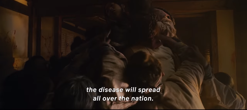 Zombies forming a mountain around a woman and eating her alive in the trailer of Netflix's Kingdom. Source: Youtube