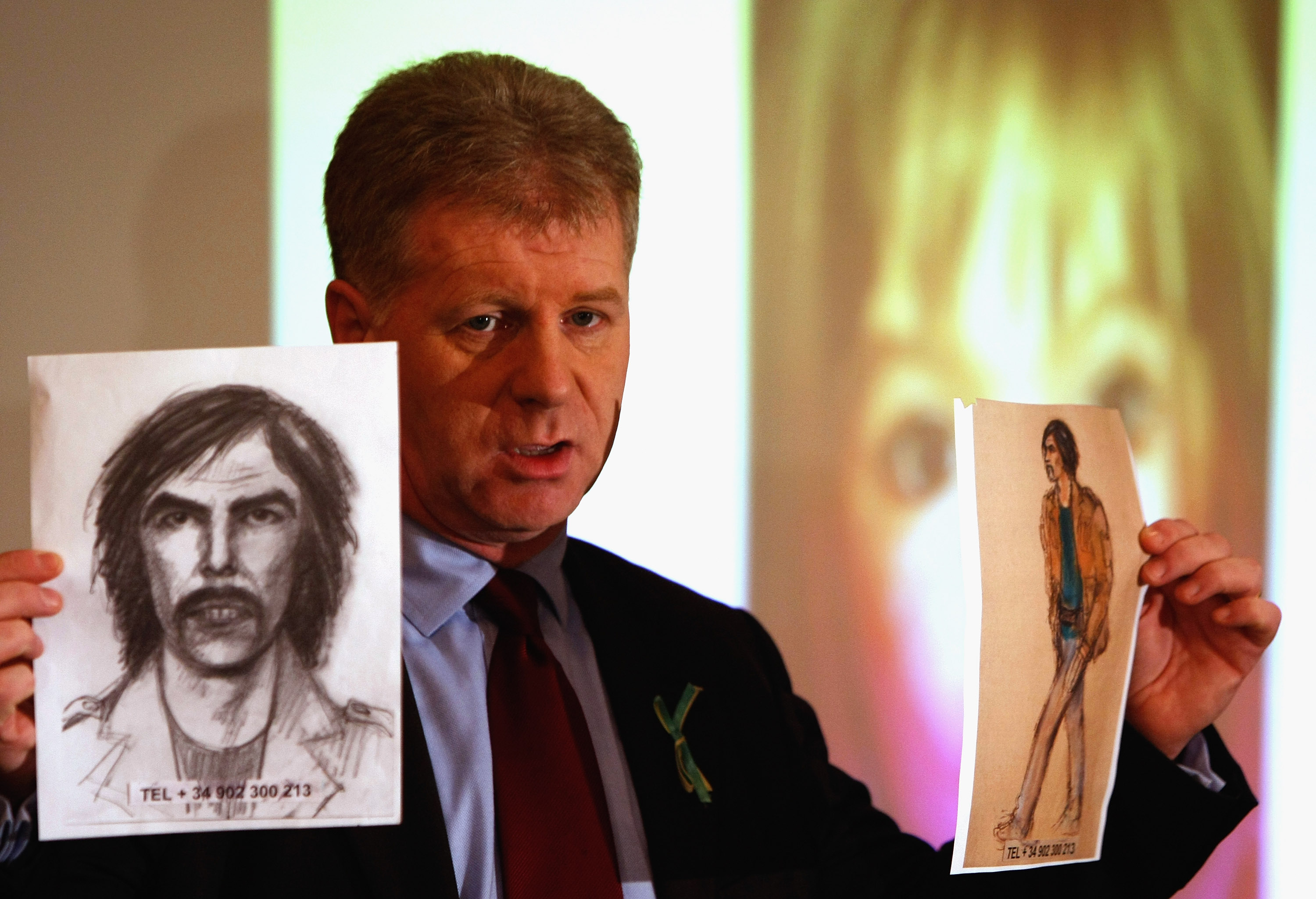 McCann family spokesman Clarence Mitchell holds two artist's impression of the new suspect on January 20, 2008, in London, England. The description has come from British woman Gail Cooper, who was staying with her family close to the McCann's apartment in Portugal. (Getty Images)