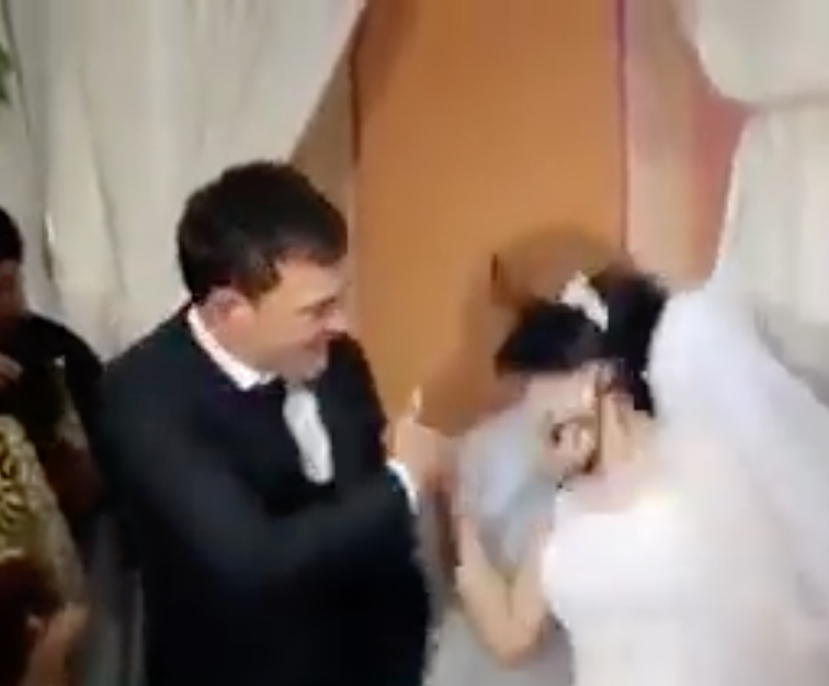 A newlywed man slaps his bride across the face (Source: Facebook)