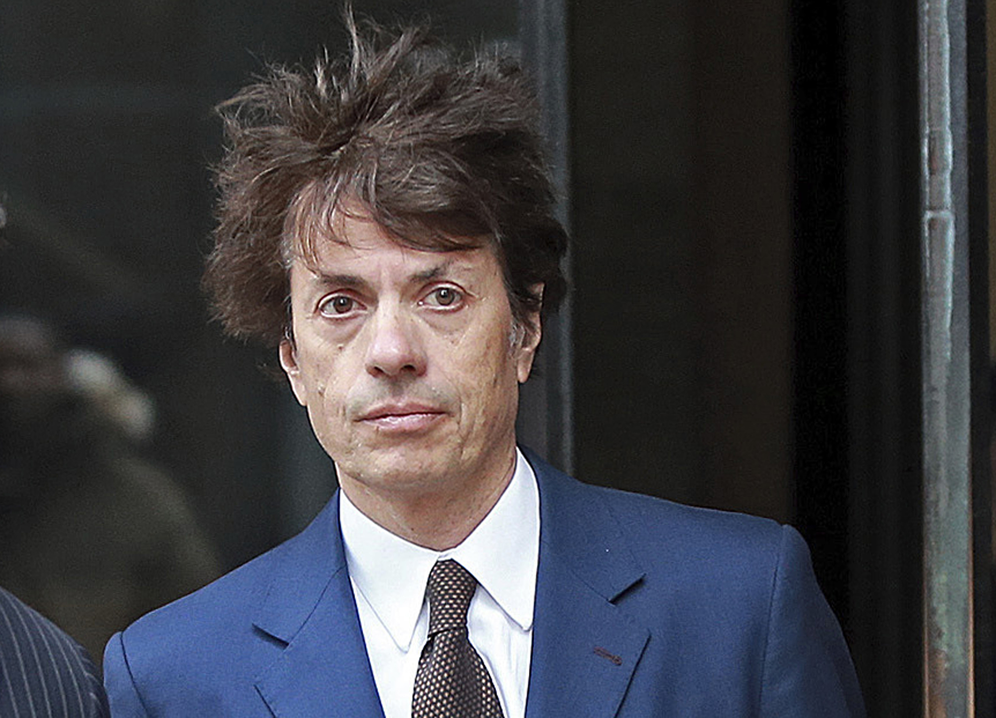 In this March 29, 2019 file photo, Agustin Huneeus, a 53-year-old San Francisco resident whose family owns vineyards in California's Napa Valley and in Oregon, leaves the federal courthouse in Boston after a hearing associated with the college admissions bribery scandal. Huneeus is accused of paying at least $50,000 to have SAT administrators correct his daughter's college entrance exam and to have the University of Southern California officials designate her as a water polo recruit. (Matt Stone/The Boston Herald via AP, File)