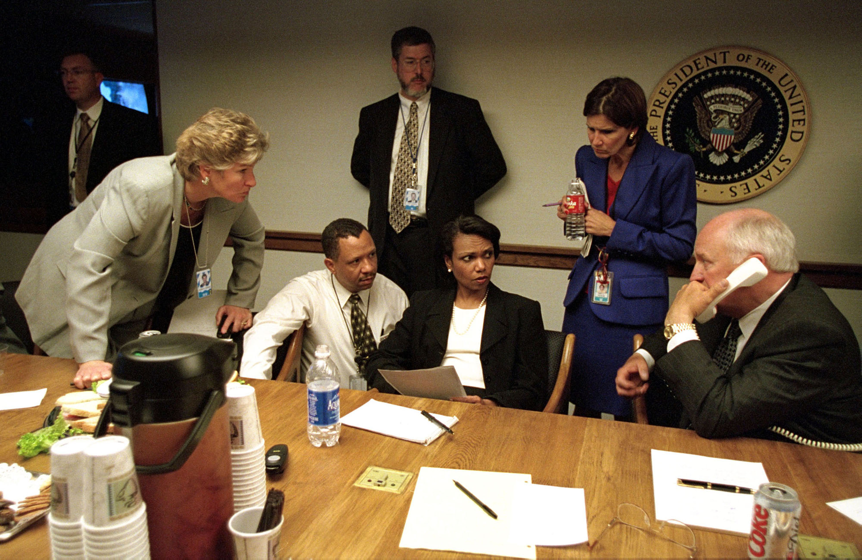 U.S. Vice President Dick Cheney (R) Speaks To President George W. Bush By Phone September 11, 2001 Inside The Operations Center At The White House After The Terrorist Attacks In Washington And New York. With Cheney Are Staff Members, Including Presidential Counselor Karen Hughes (L) And National Security Adviser Condoleezza Rice (C). (Getty Images)