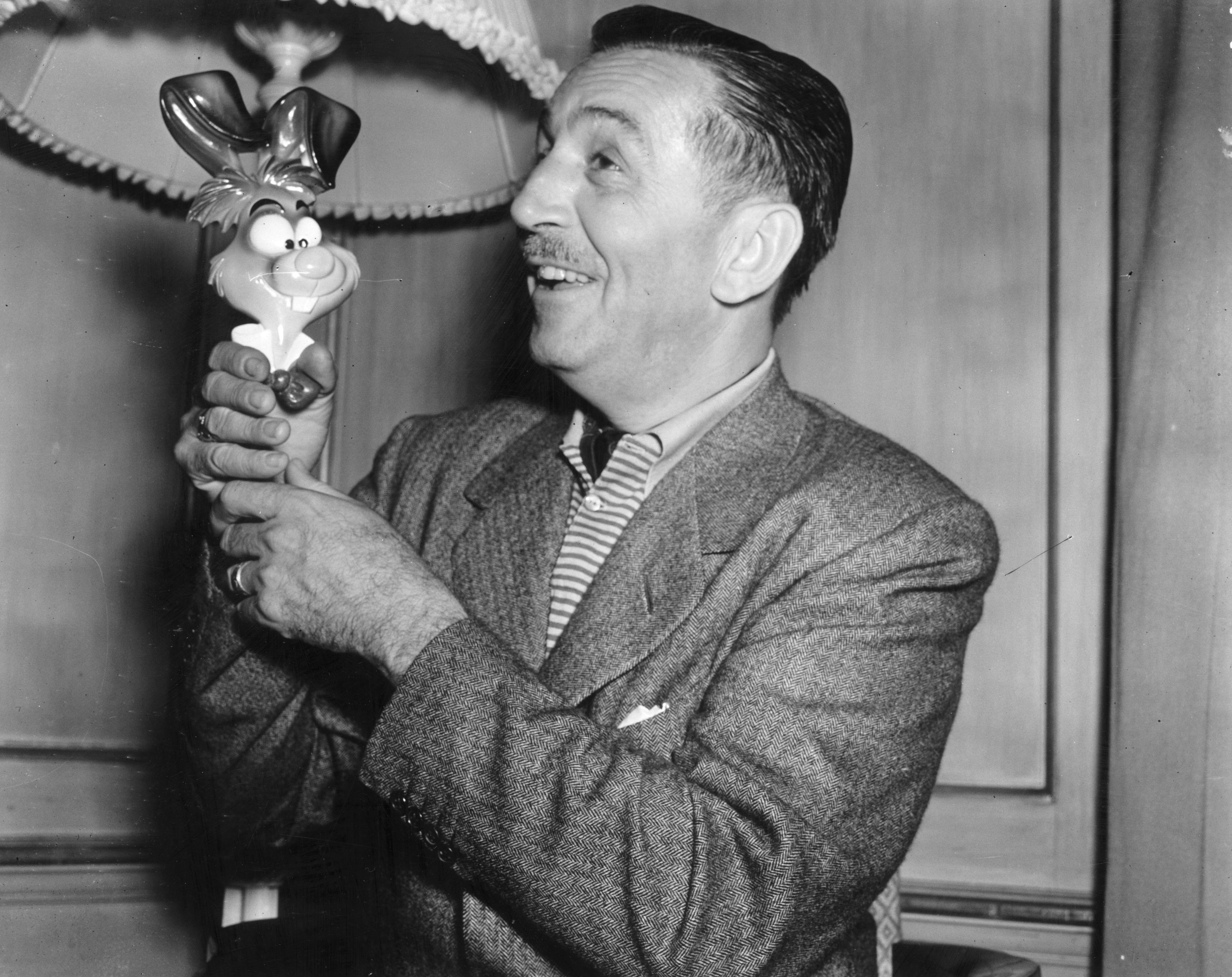 American animator and producer, Walt Disney (1901-1966), in London with one of the characters from his new film, 'Alice In Wonderland' (Getty Images)