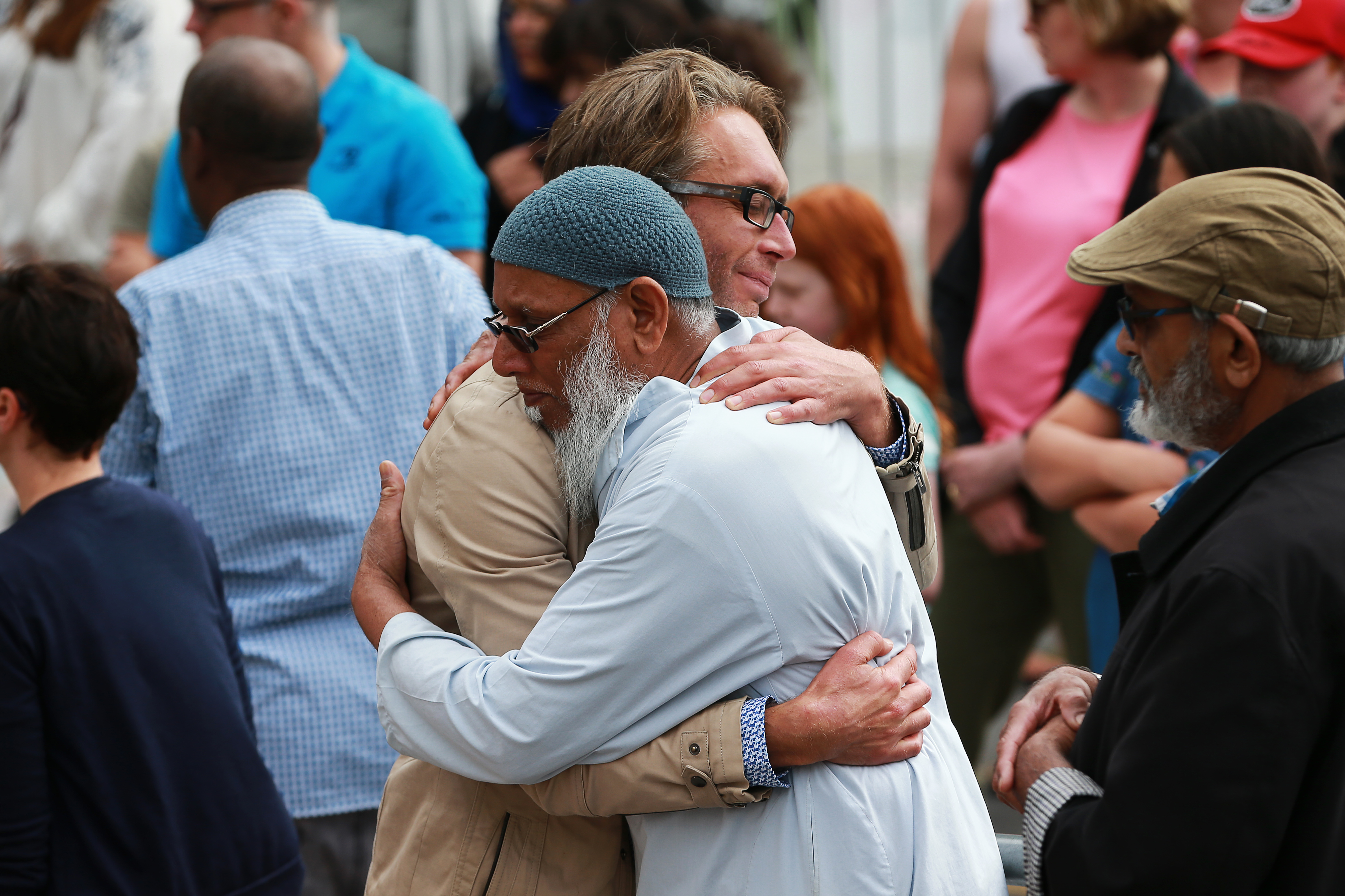 A member of the public and a mosque-goer embrace at the Kilbirnie Mosque on March 17, 2019, in Wellington, New Zealand. (Getty)