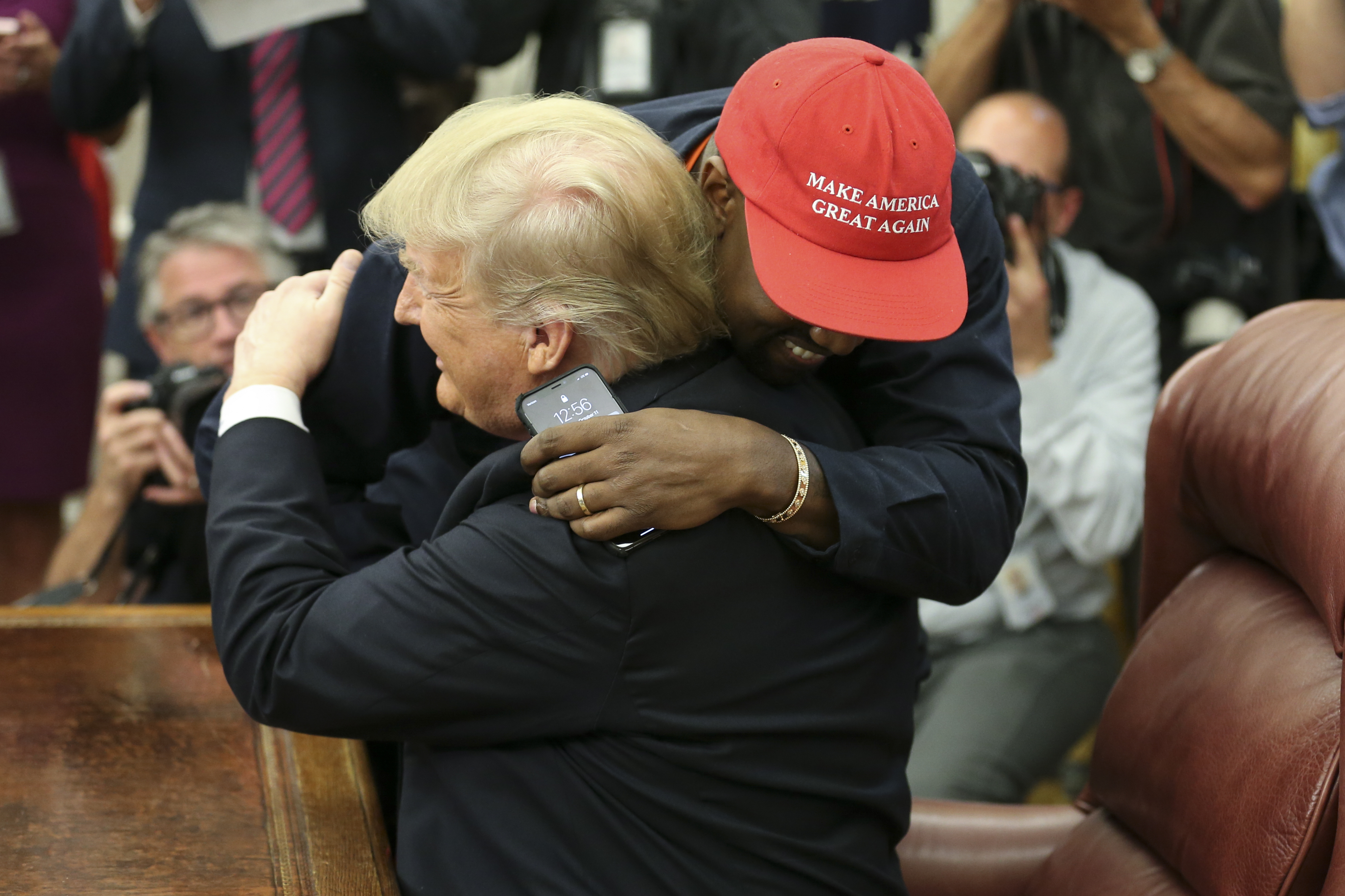 U.S. President Donald Trump hugs rapper Kanye West during a meeting in the Oval Office of the White House on October 11, 2018, in Washington, DC. (Getty)