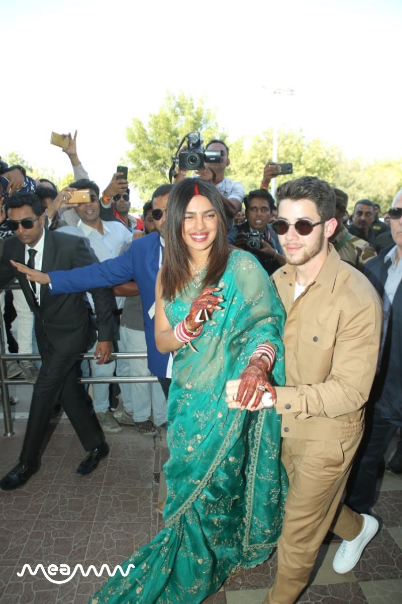 Both Priyanka and Nick looked completely besotted wth each other as they held hand and posed for pictures outside the Jodhpur airport terminal. (Meaww Photos)