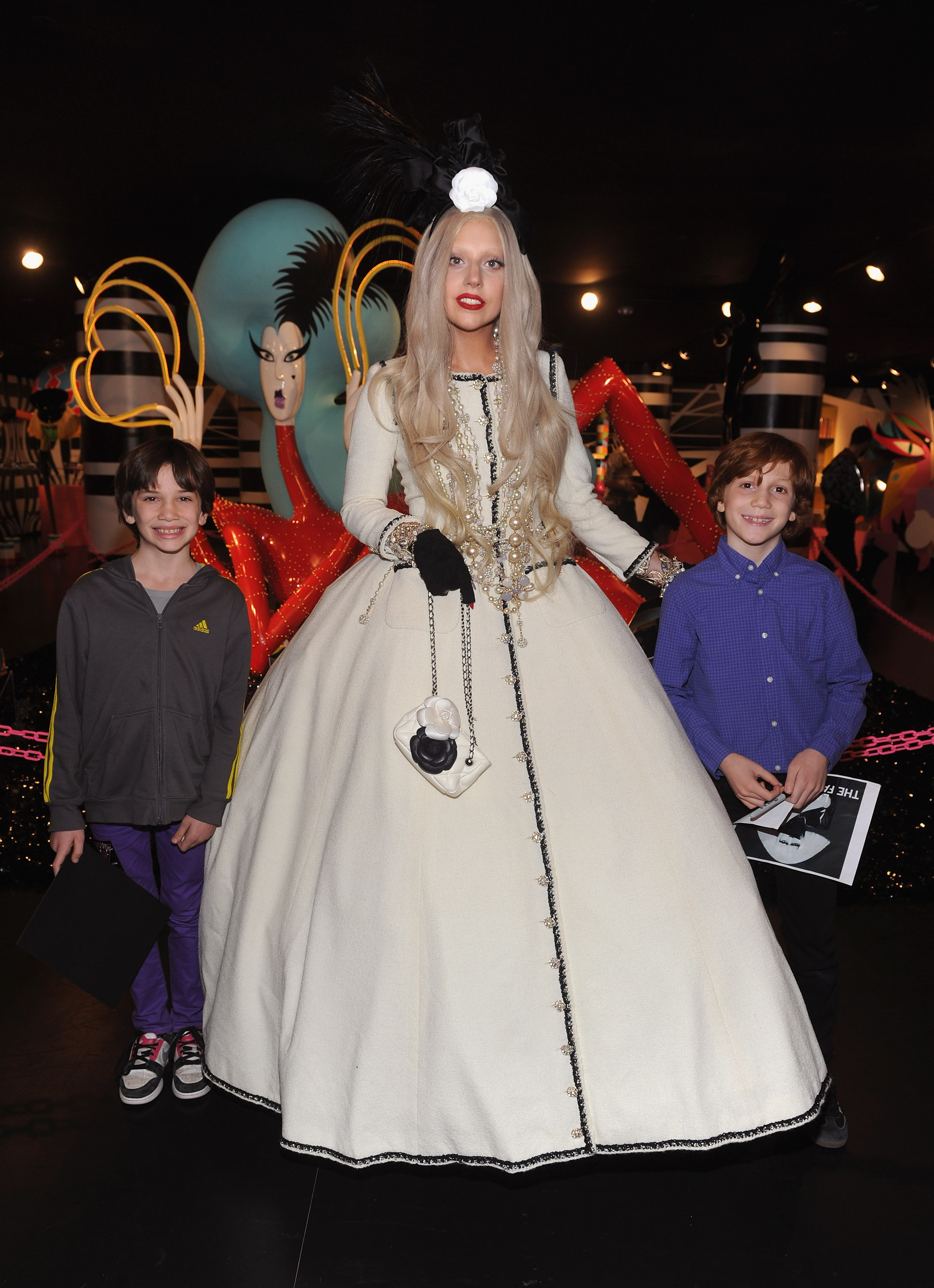 Lady Gaga poses with young fans in Gaga's Workshop at Barneys New York on November 21, 2011 in New York City.