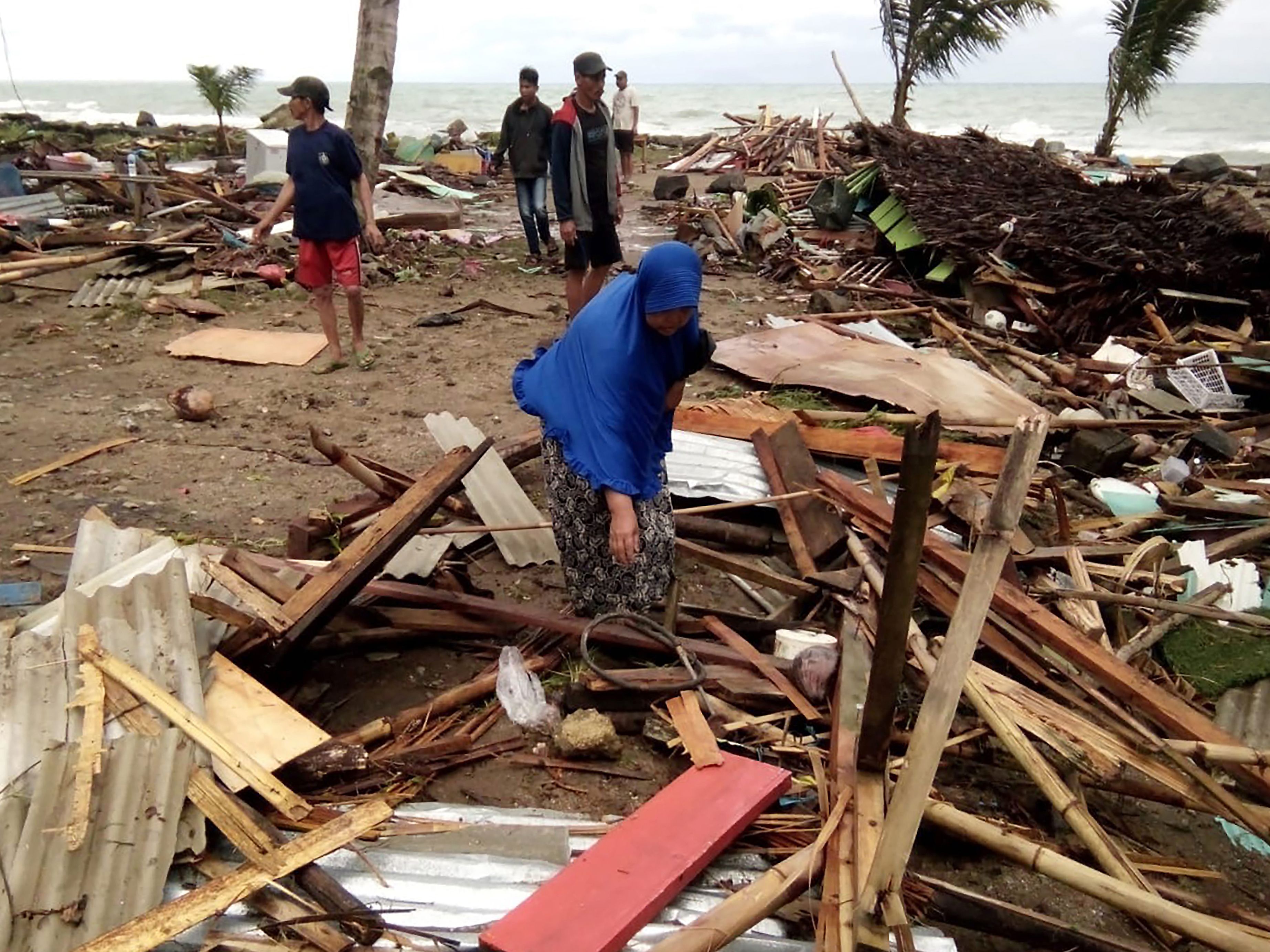 Residents inspect the damage to their homes on Carita beach on December 23, 2018, after the area was hit by a tsunami on December 22 that may have been caused by the Anak Krakatoa volcano. - At least 43 people have been killed and nearly 600 injured in a tsunami in Indonesia that may have been caused by a volcano known as the 'child' of the legendary Krakatoa, officials said on December 23. Hundreds of buildings were destroyed by the wave, which hit beaches without warning in South Sumatra and the western tip of Java about 9.30 pm local time (1430 GMT) on December 22, national disaster agency spokesman Sutopo Purwo Nugroho said in a statement. (SEMI/AFP/Getty Images)