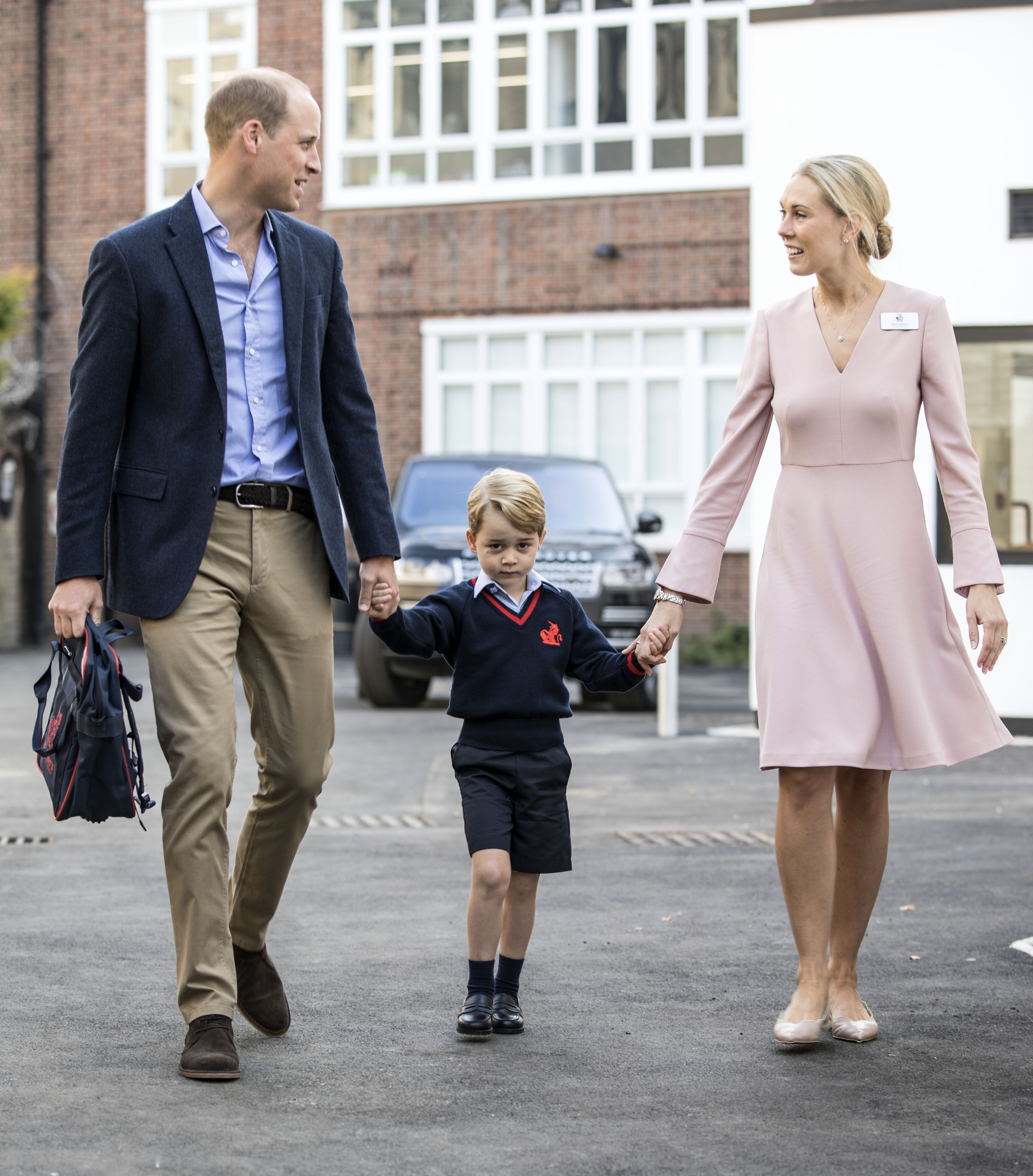 Prince George of Cambridge arrives for his first day of school with his father Prince William, Duke of Cambridge as they are met Head of the lower school Helen Haslem at Thomas's Battersea on September 7, 2017 in London, England