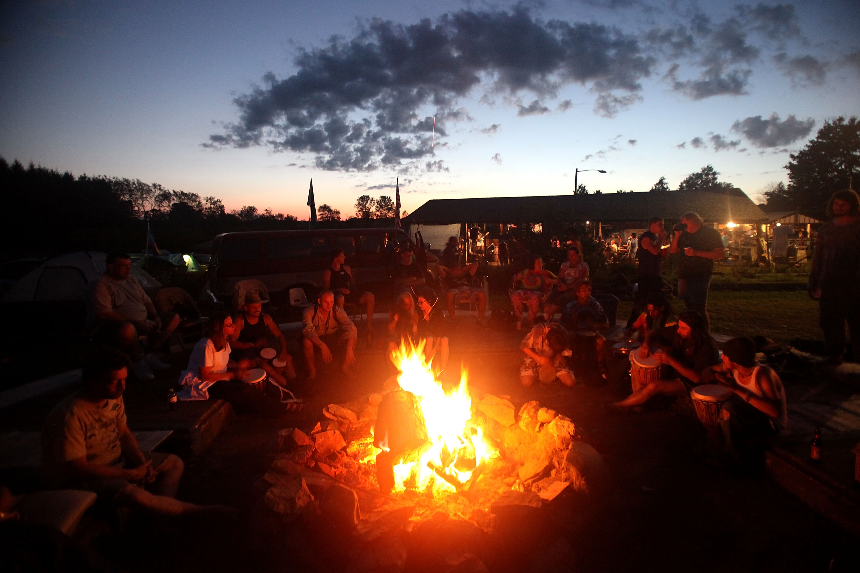 People gather at dusk as the 40th anniversary of the Woodstock music festival approaches August 14, 2009 in Bethel, New York. On August 15-17 in 1969 an estimated 400,000 music fans gathered on Max Yasgur's farm in Bethel, N.Y. for the most celebrated music festival ever. (Image source: Getty Images)