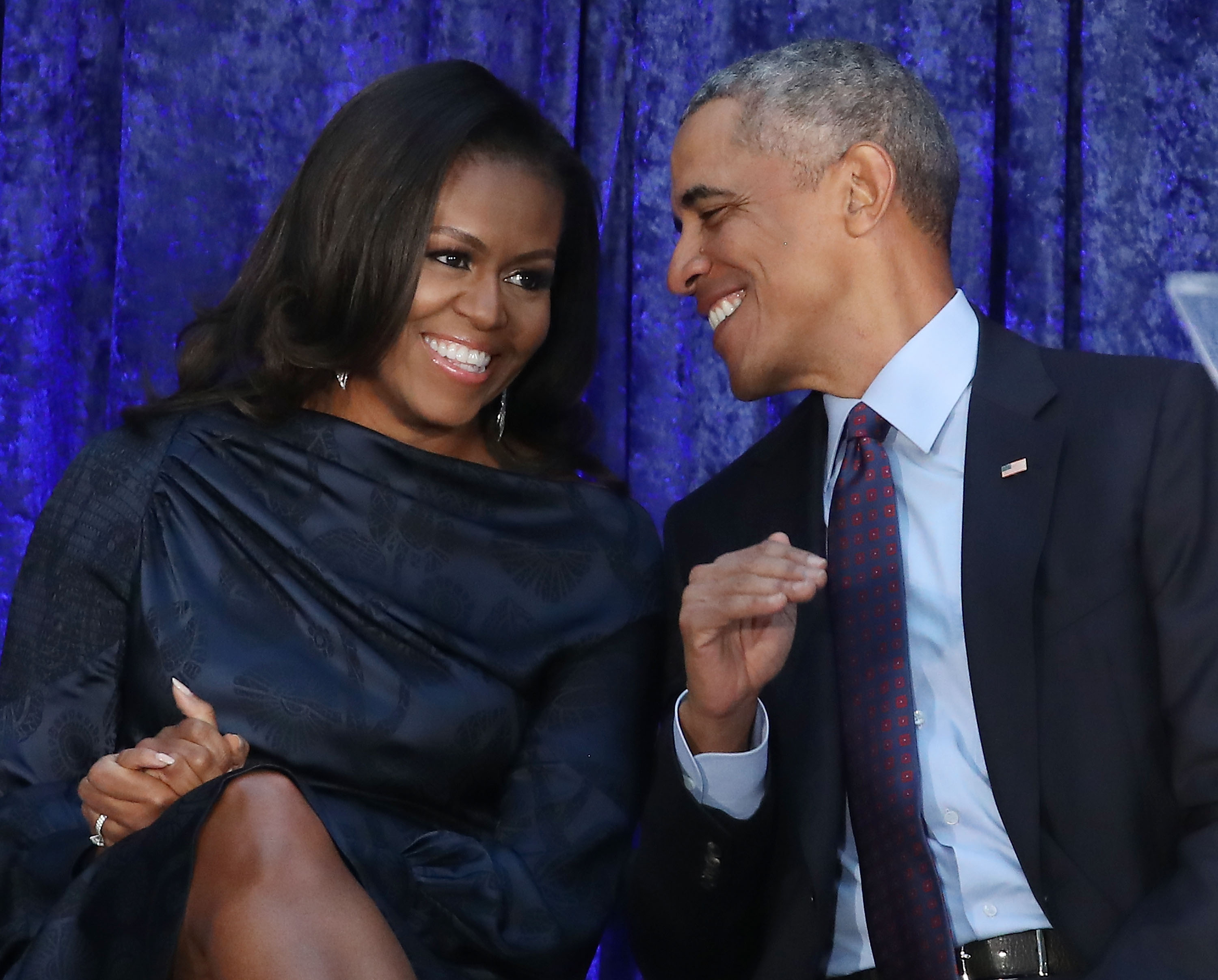 Former U.S. President Barack Obama and first lady Michelle Obama participate in the unveiling of their official portraits during a ceremony at the Smithsonian's National Portrait Gallery, on February 12, 2018 in Washington, DC. The portraits were commissioned by the Gallery, for Kehinde Wiley to create President Obama's portrait, and Amy Sherald that of Michelle Obama.
